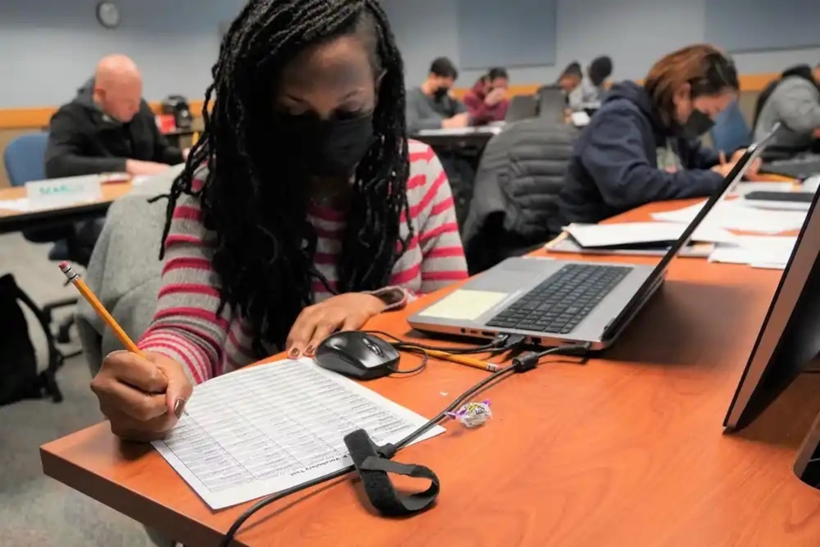 Staff Sgt. Curtstein Luckett, left, and Staff Sgt. Christina House, focus on completing a practical exercise during the Basic Skills Education Program course held at the 88th Readiness Division Education Center, Fort McCoy, Wis., in January 2022. (Army photo by Cheryl Phillips)