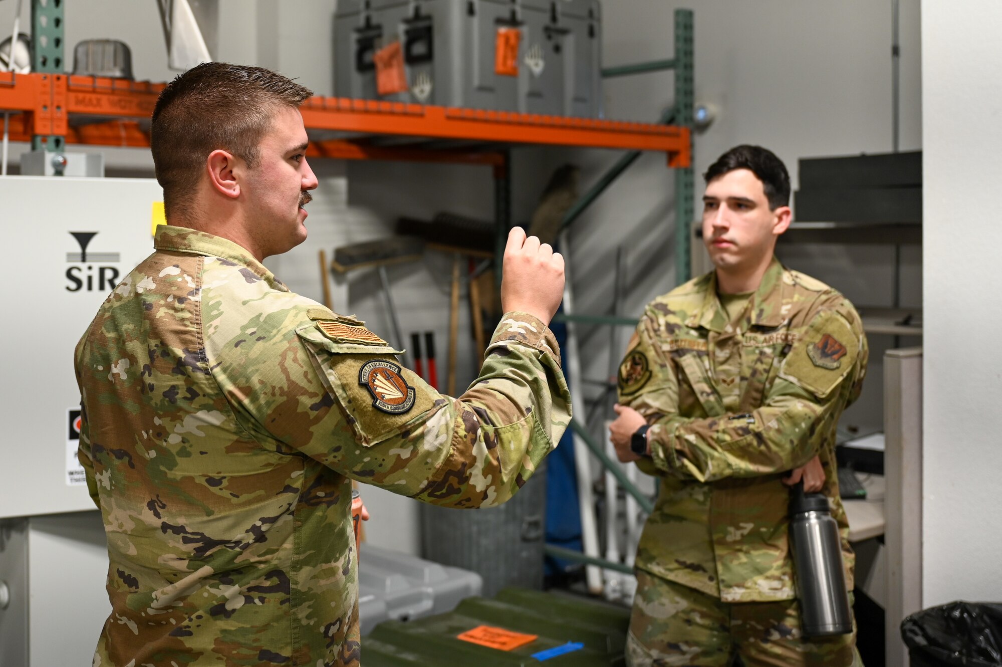 A photo of Airmen talking.