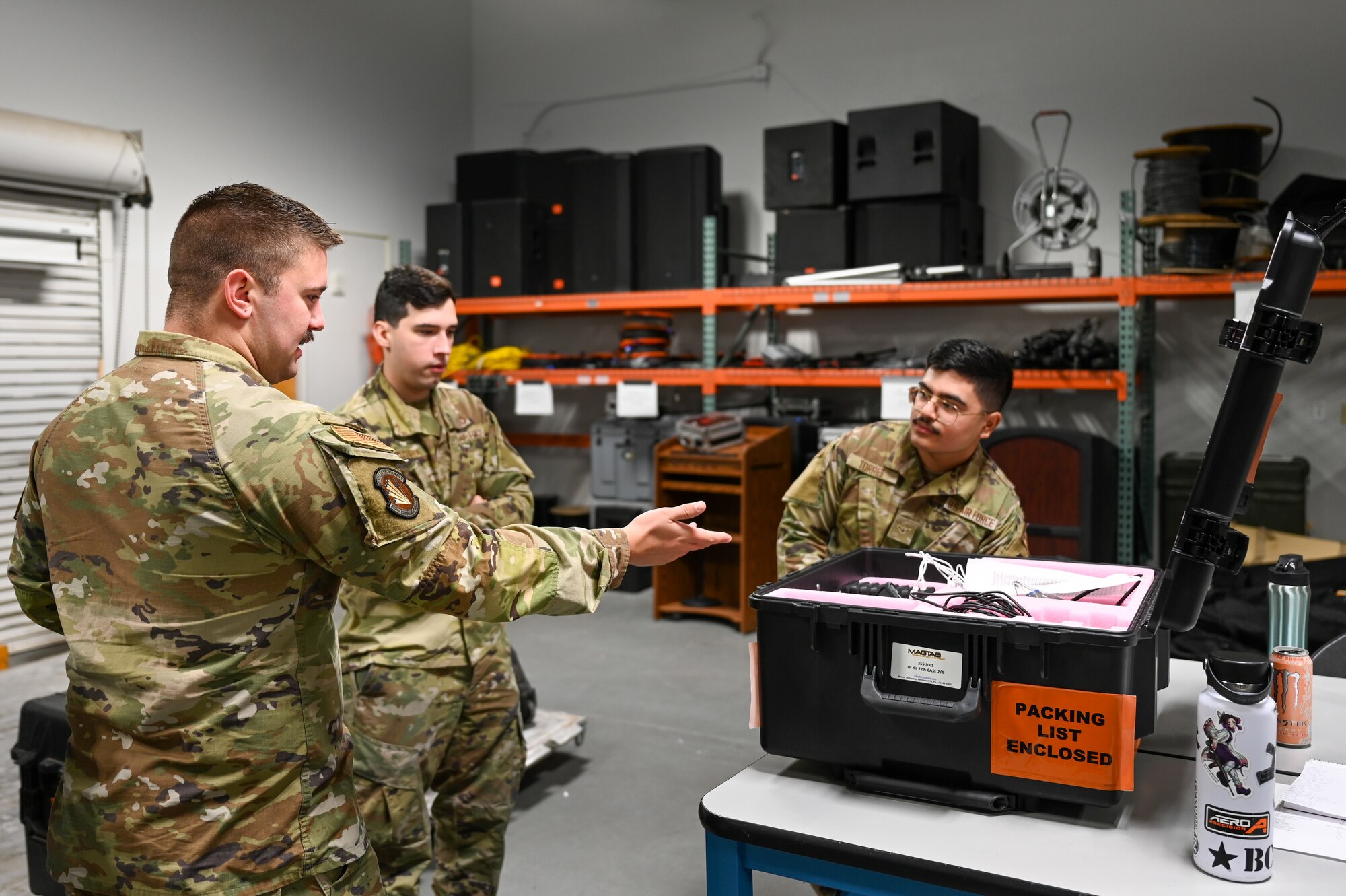 A photo of Airmen looking at radio equipment.