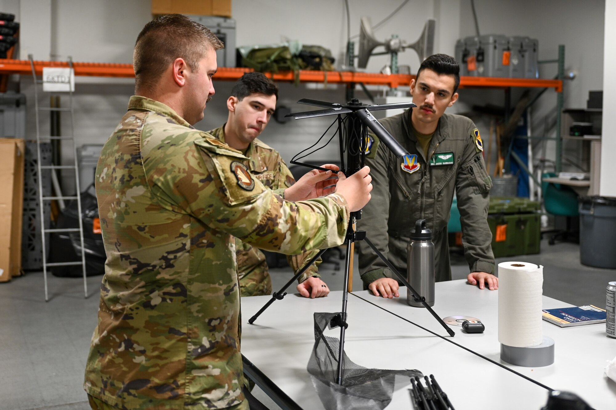 A photo of Airmen putting together an antenna.