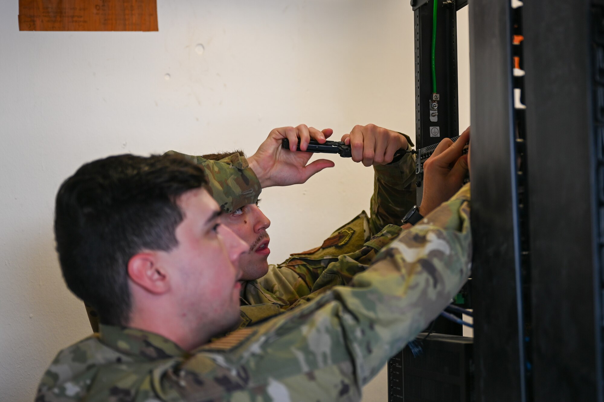 A photo of Airmen installing a console.