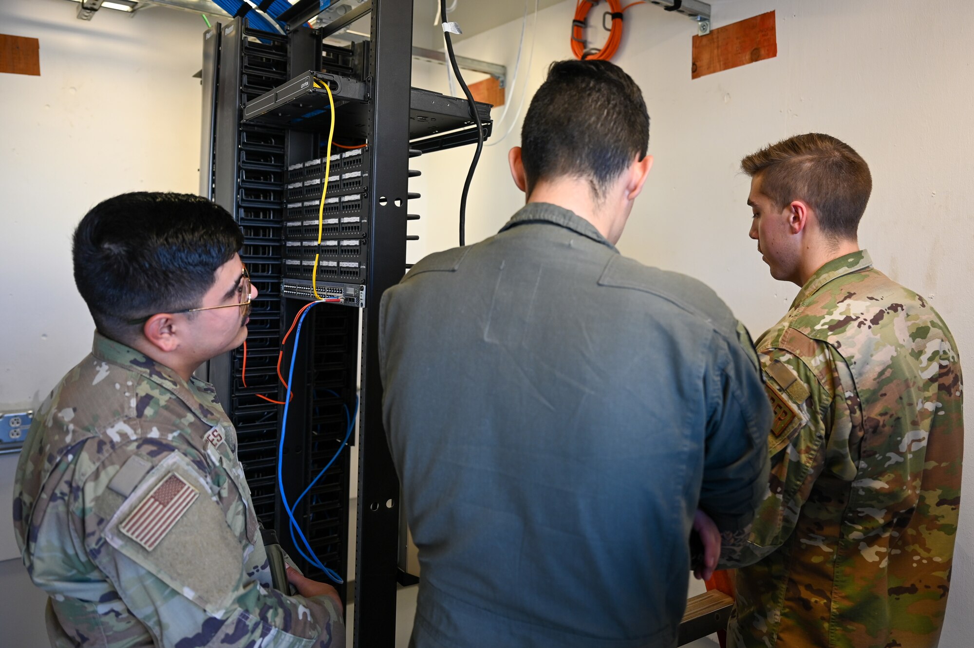 A photo of Airmen fixing a computer.