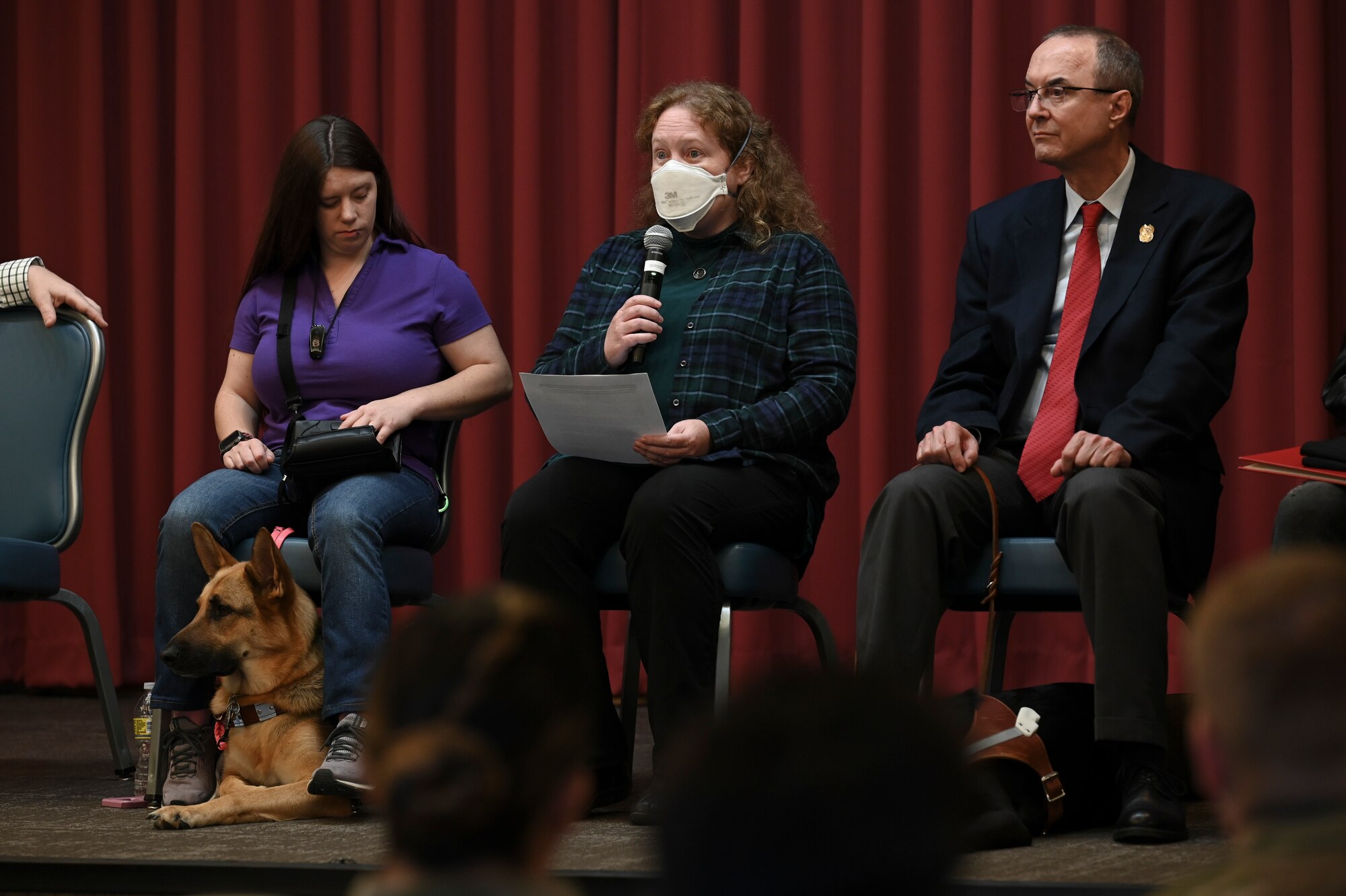 A group of people share stories on a stage.