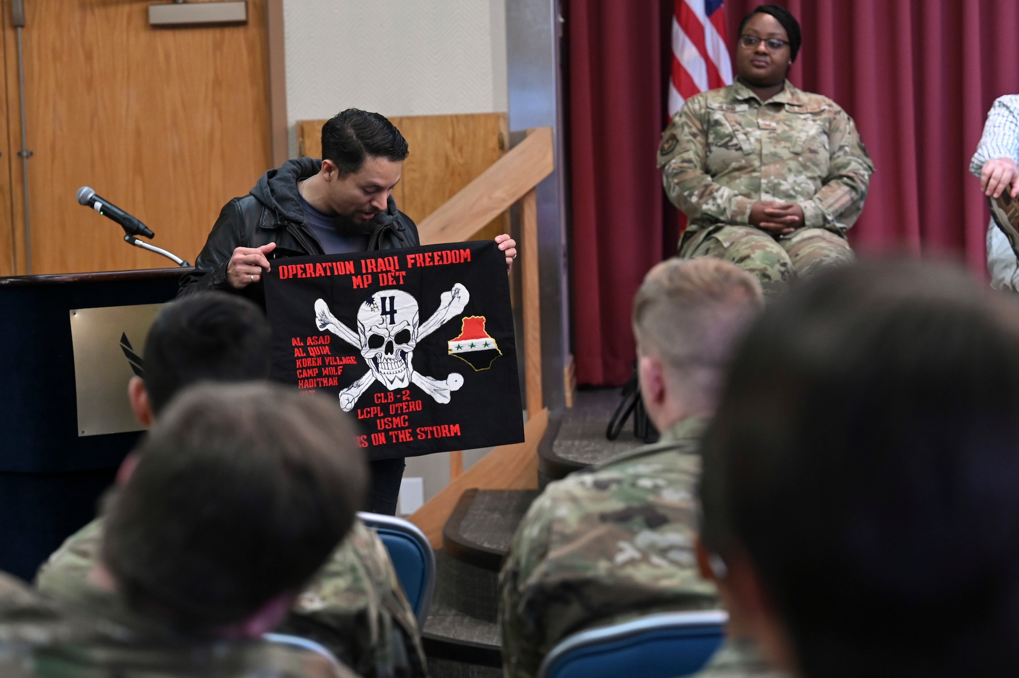 A man shows a flag to a group of people.