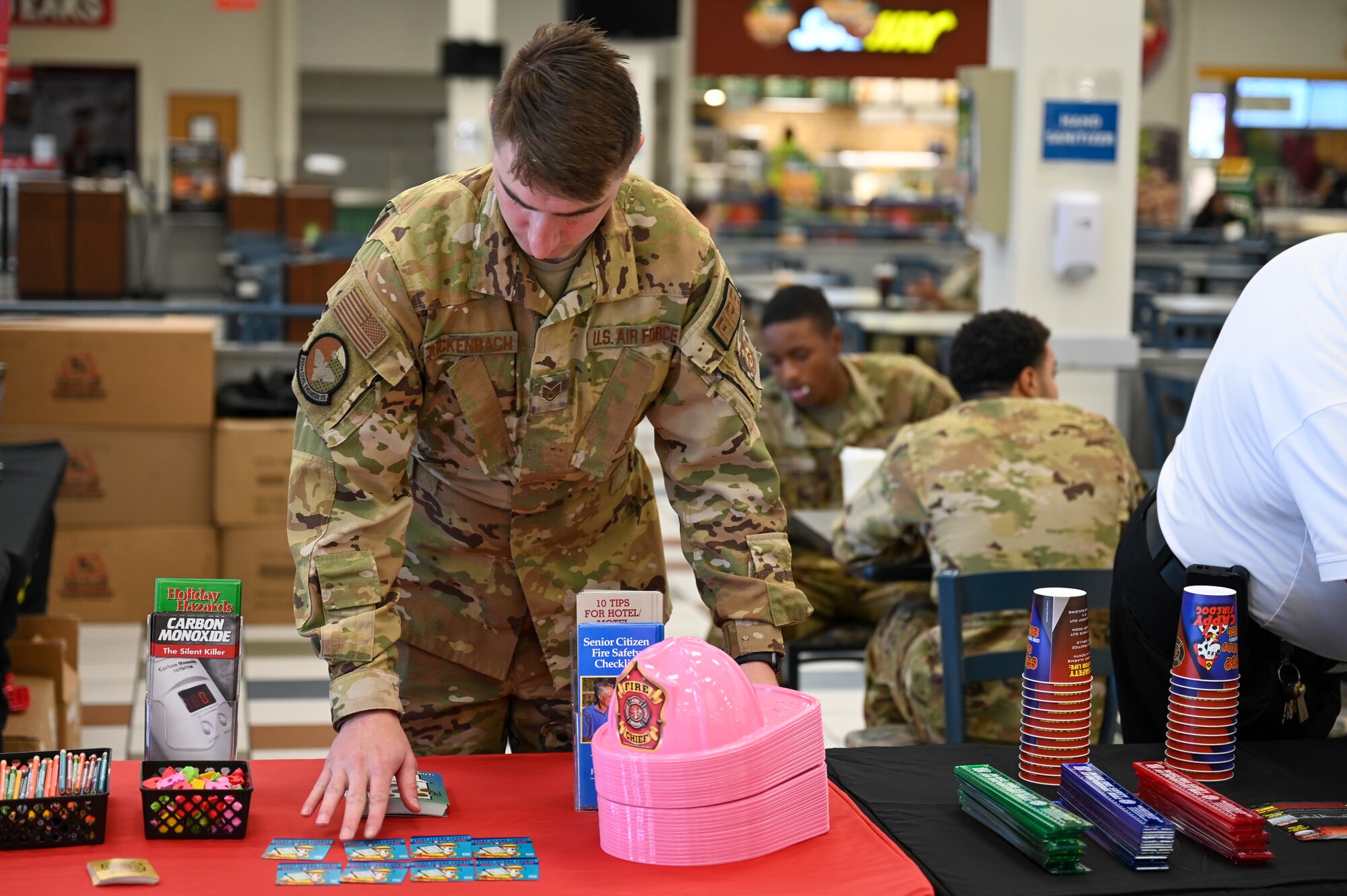 A photo of an Airman setting up a fire prevention booth.