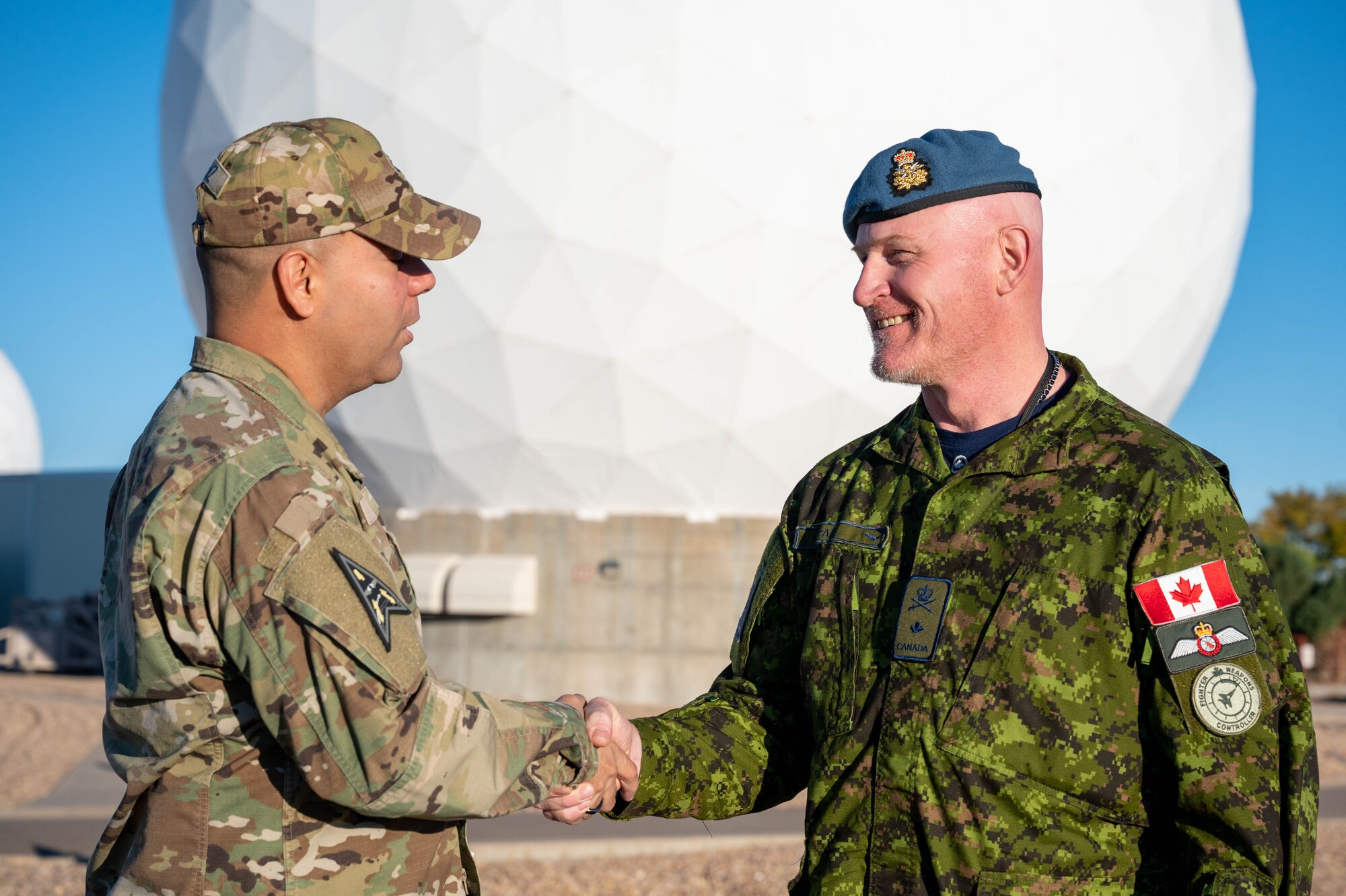 From left to right, Col. Miguel Cruz, Space Delta 4 commander, shakes hands with Brig. Gen. Kyle Paul, Deputy Commanding General, Transformation, Space Operations Command, within the restricted area at Buckley Space Force Base, Colo., Oct. 11, 2022. Paul received multiple briefings from members of various space warning squadrons supporting Space Delta 4. (U.S. Space Force photo by Airman 1st Class Shaun Combs)