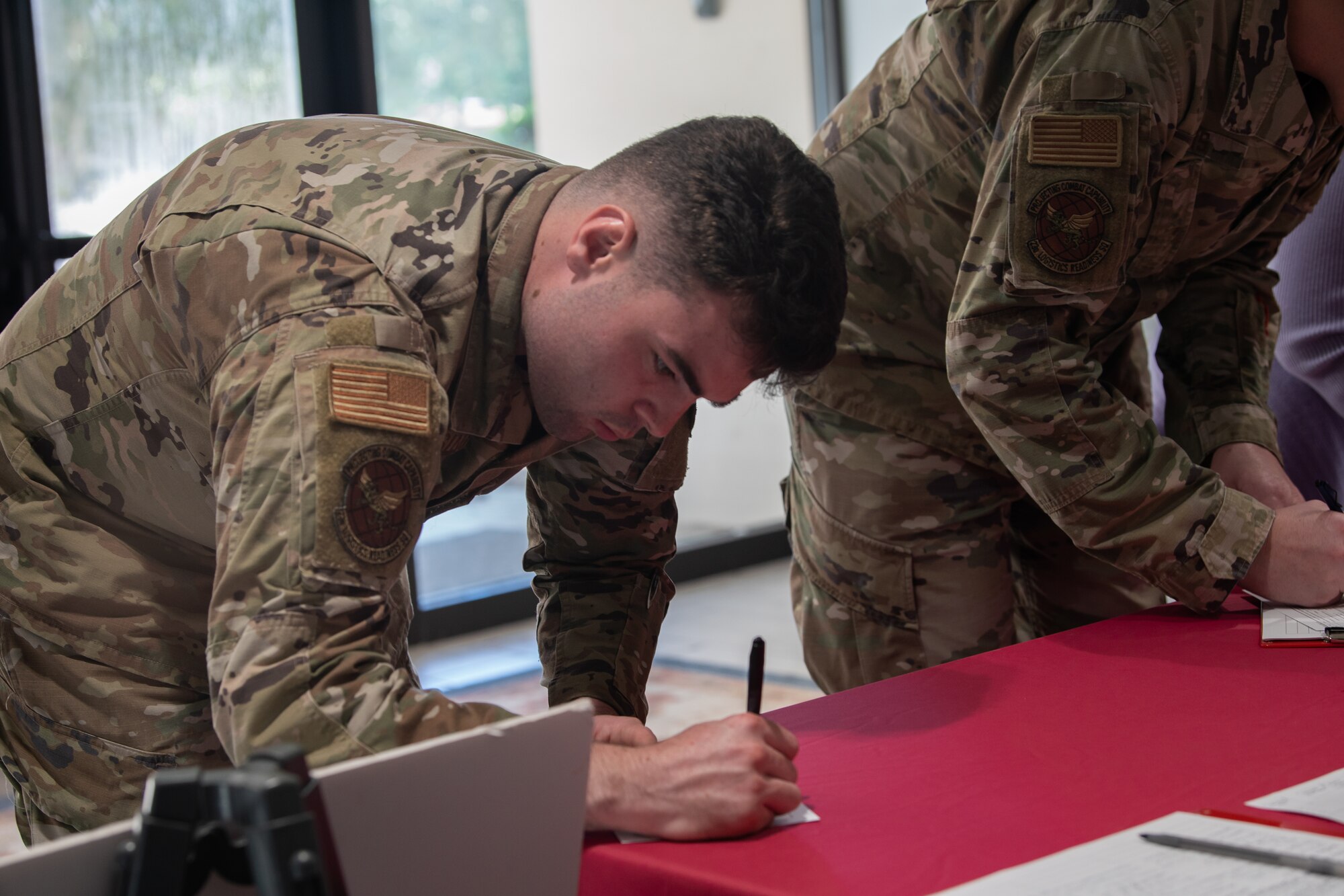 man in uniform signing paper