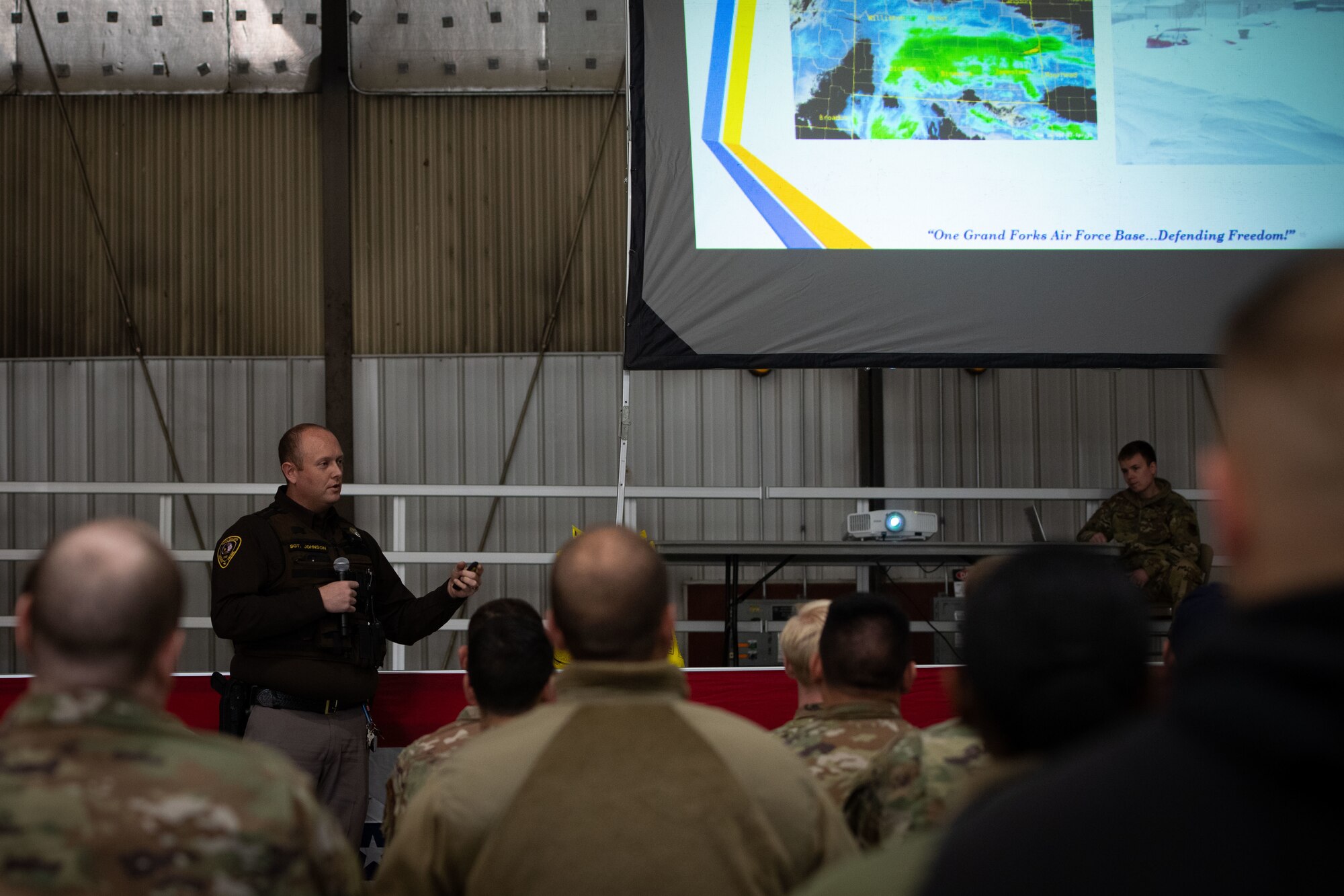 North Dakota State Highway Patrol SGT Matthew Johnson speaks about winter driving safety Oct. 7, 2022, at the year end training initiative at Grand Forks Air Force Base, North Dakota. During the YETI, airmen and families learned about proper winter clothing, snow removal, and how to build a winter car kit.  (U.S. Air Force photo by Senior Airman Phyllis Jimenez)