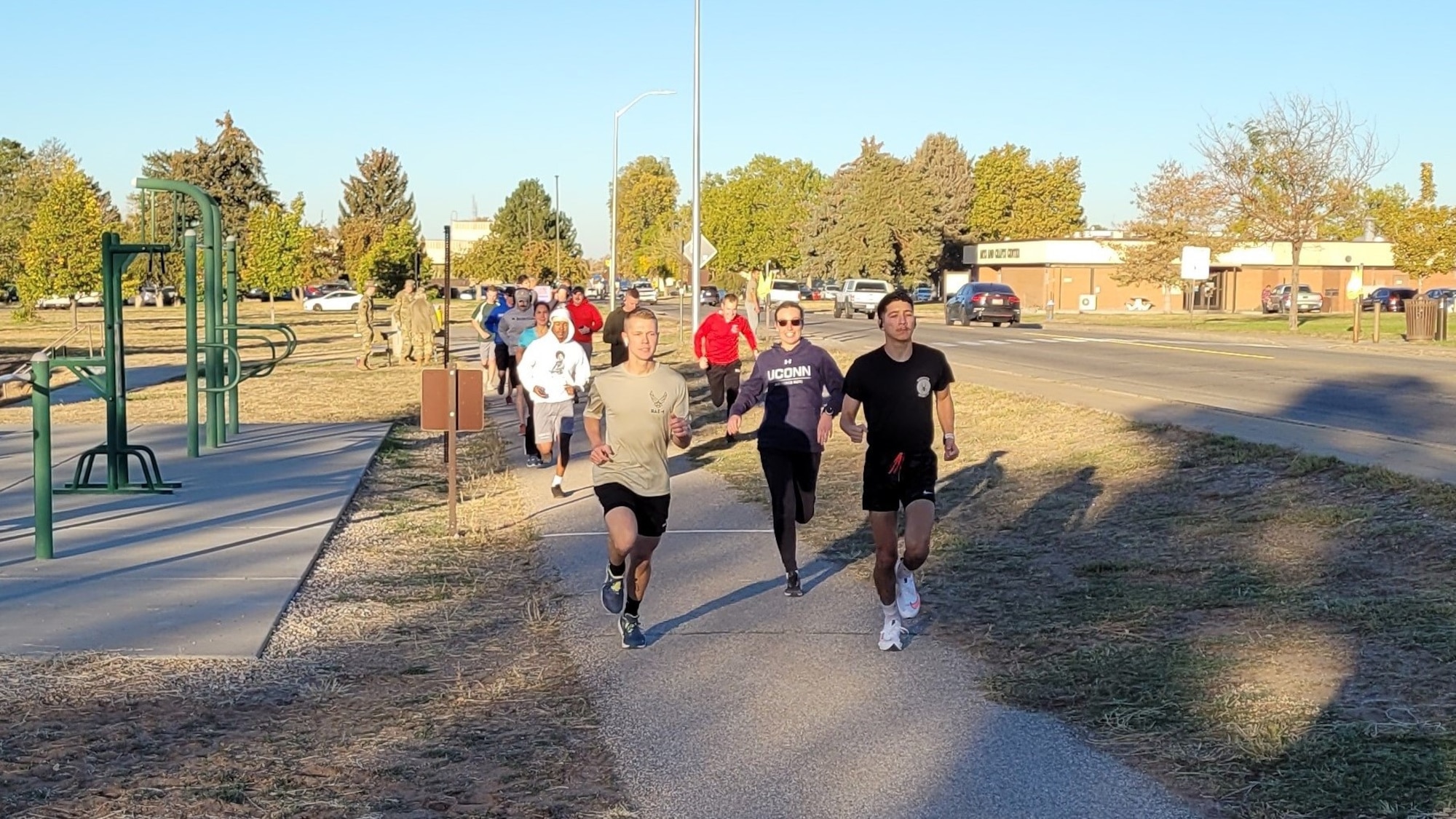 A pack of runners on an asphalt trail.