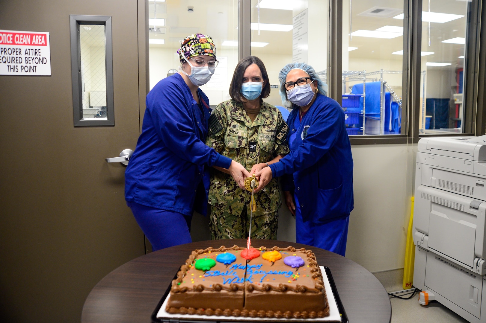 SAN DIEGO (Oct. 12, 2022) Capt. Kim Davis, Navy Medicine Readiness and Training Command San Diego’s commanding officer (center), Hospitalman Falon Olver (left), and Conchita Unger (right), cut a cake during a Sterile Processing Week celebration at the hospital. NMRTC San Diego celebrates Sterile Processing Week to recognize the important role its specialists working in the Sterile Processing Department hold in patient care. NMRTC San Diego's mission is to prepare service members to deploy in support of operational forces, deliver high quality healthcare services and shape the future of military medicine through education, training and research. NMRTC San Diego employs more than 6,000 active duty military personnel, civilians and contractors in Southern California to provide patients with world-class care anytime, anywhere. (U.S. Navy photo by Mass Communication Specialist 3rd Class Raphael McCorey)