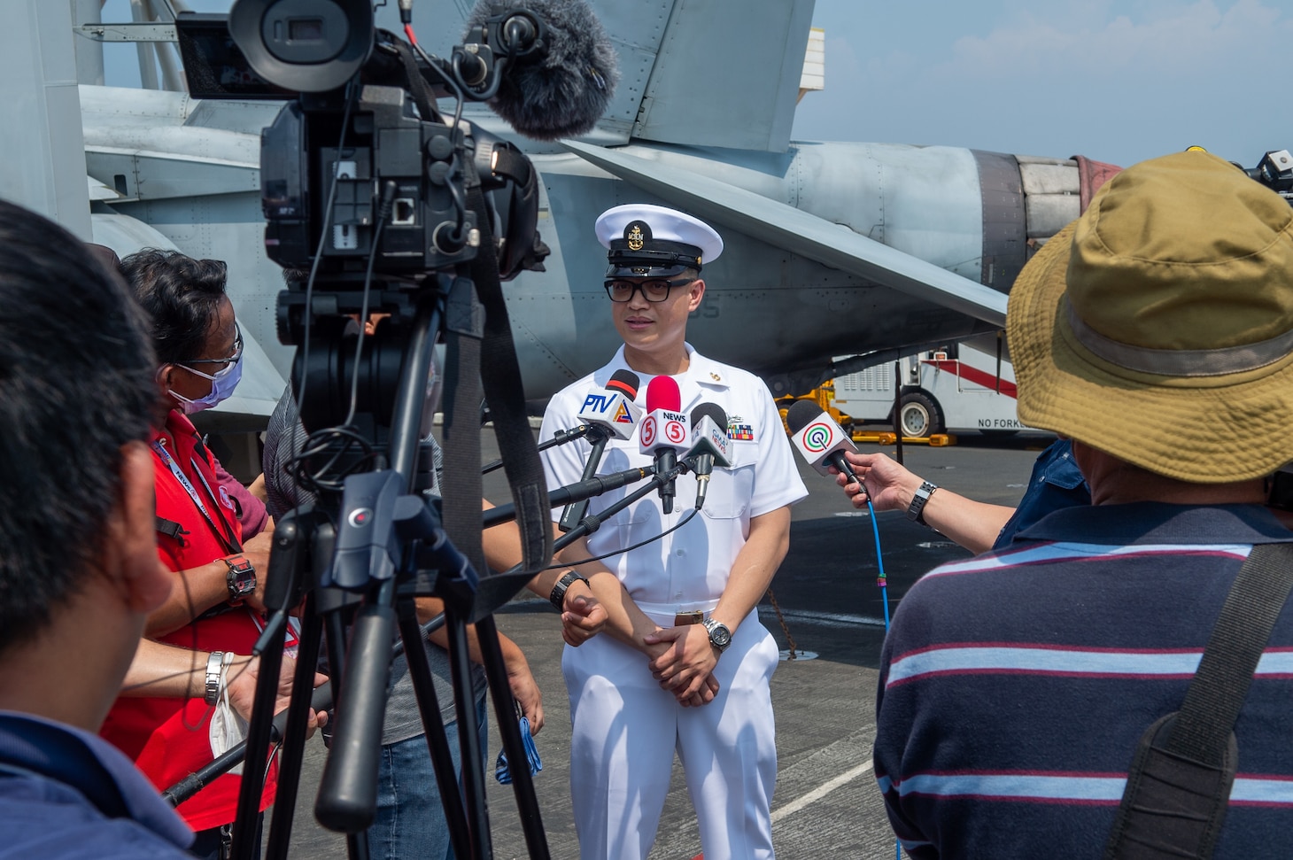 221014-N-IG750-1062 MANILA BAY (Oct. 14, 2022) Senior Chief Gas Turbine Systems Technician Brian Sacman, from Durham, North Carolina, answers interview questions from local media outlets on the flight deck of the U.S. Navy’s only forward-deployed aircraft carrier, USS Ronald Reagan (CVN 76), while at anchor in Manila Bay, Philippines, Oct. 14. Ronald Reagan, the flagship of Carrier Strike Group 5 provides a combat-ready force that protects and defends the United States, and supports alliances, partnerships and collective maritime interests in the Indo-Pacific region. (U.S. Navy photo by Mass Communication Specialist 2nd Class Caleb Dyal)