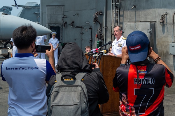 221014-N-IG750-1023 MANILA BAY (Oct. 14, 2022) Rear Adm. Buzz Donnelly, Commander, Carrier Strike Group (CSG) 5, speaks at a press conference on the flight deck of the U.S. Navy’s only forward-deployed aircraft carrier, USS Ronald Reagan (CVN 76), as the ship is anchored in Manila Bay, Philippines, Oct. 14. Ronald Reagan, the flagship of CSG 5 provides a combat-ready force that protects and defends the United States, and supports alliances, partnerships and collective maritime interests in the Indo-Pacific region. (U.S. Navy photo by Mass Communication Specialist 2nd Class Caleb Dyal)