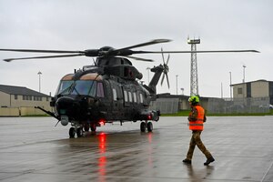 Italian Maintainer walking towards helicopter