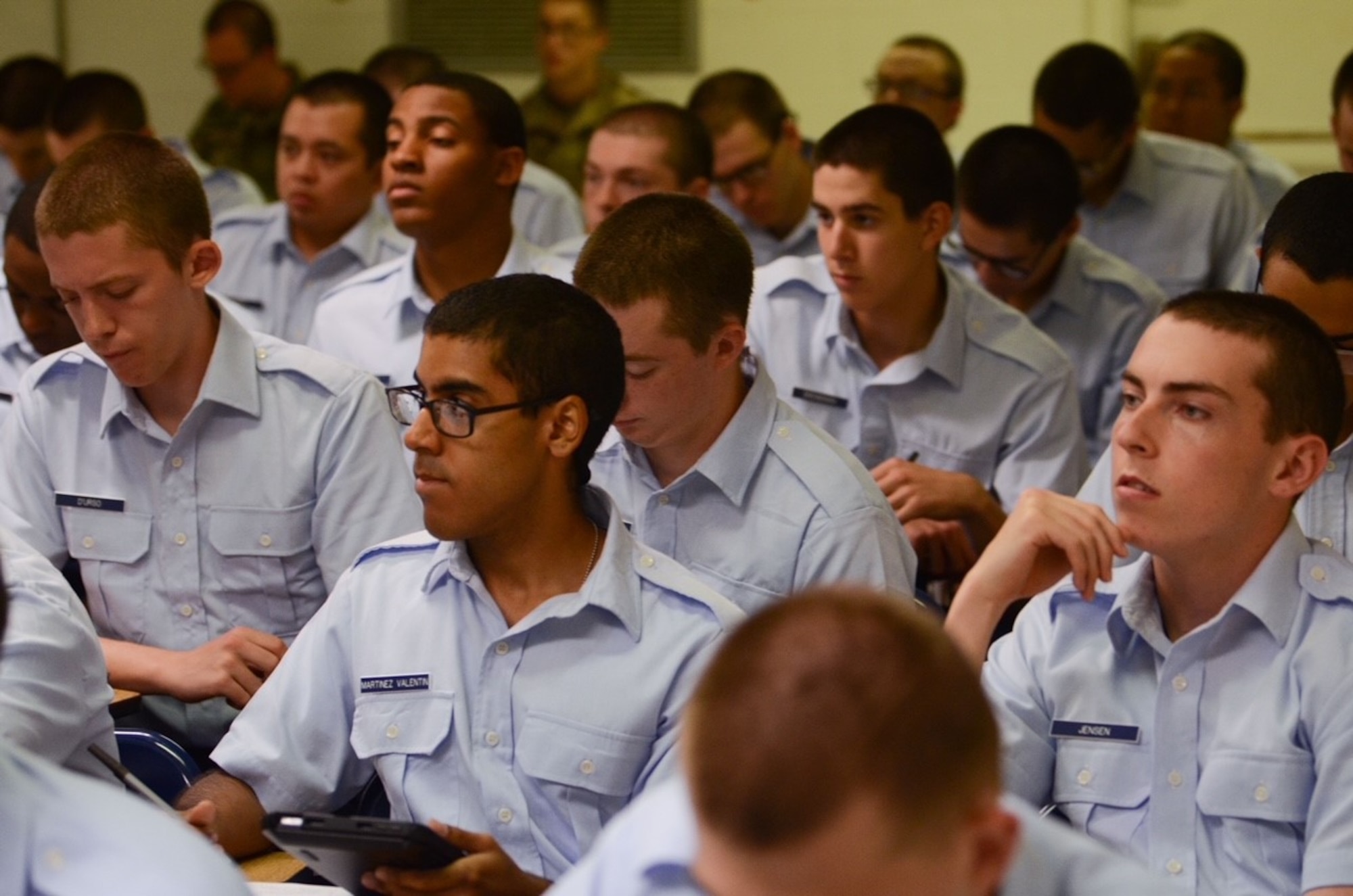 Multiple students setting at desks.