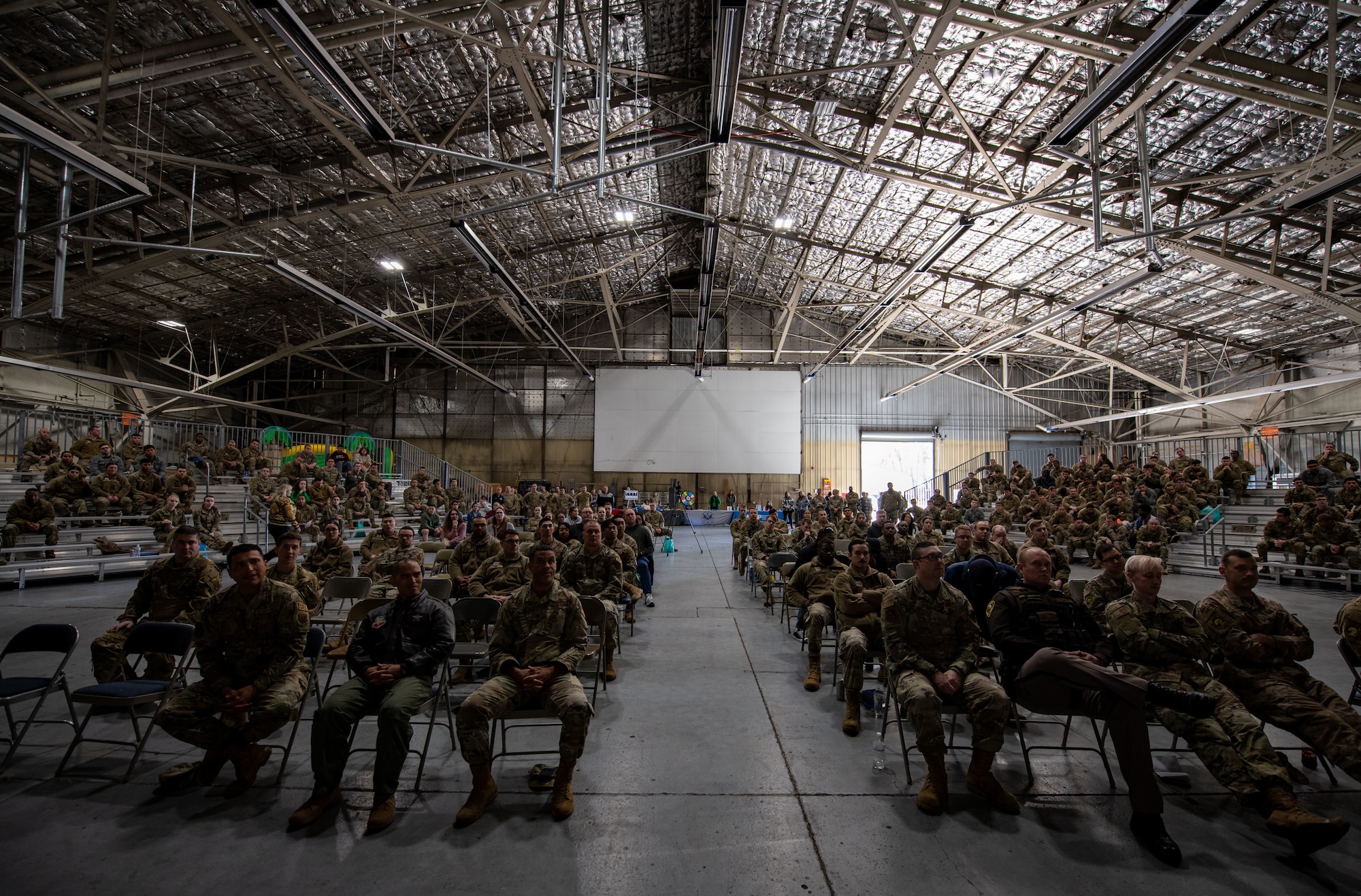 Airmen assigned to the 319th Reconnaissance Wing attend the year end training initiative brief Oct. 7, 2022, at Grand Forks Air Force Base, North Dakota. Topics briefed during the YETI included proper winter clothing, snow removal, safe winter driving and winter car kits.  (U.S. Air Force photo by Senior Airman Phyllis Jimenez)