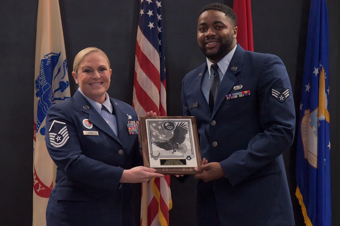 U.S. Air Force Master Sgt. Elizabeth Mann, 17th Force Support Squadron Airman Leadership School commandant, awards the commandant’s award to Senior Airman Joshua Thompson, 17th Training Support Squadron cyber system operator, Goodfellow Air Force Base, Texas, Oct. 14, 2022. The commandant’s award is one of four awards given during ALS graduation. (U.S. Air Force photo Senior Airman Michael Bowman)