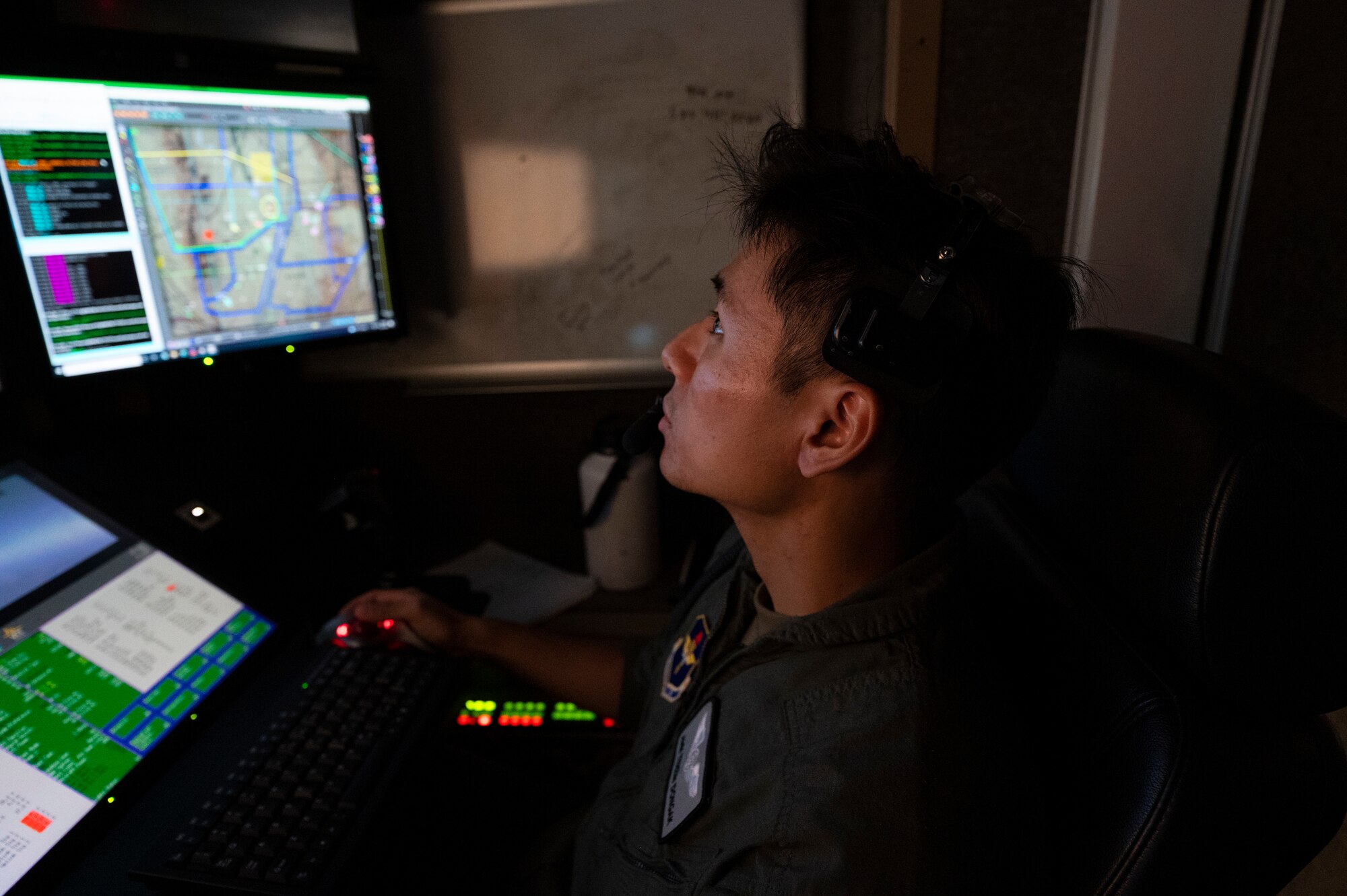 U.S. Air Force Airman Tenzin Dongak, 6th Attack Squadron student sensor operator, monitors video feed from an MQ-9 Reaper in a ground control station, Holloman Air Force Base, New Mexico, Oct. 13, 2022. During the training exercise, sensor operator students utilized newly learned skills in video and image surveillance, such as monitoring airborne, maritime and ground objects to complete the simulated mission. (U.S. Air Force photo by Airman 1st Class Isaiah Pedrazzini)