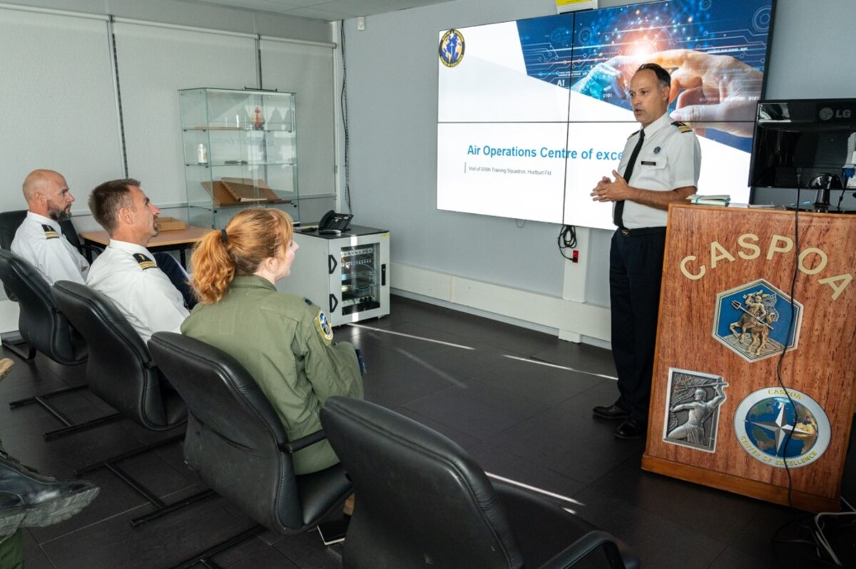 photo of French air force member briefing a  US military member sitting in chairs