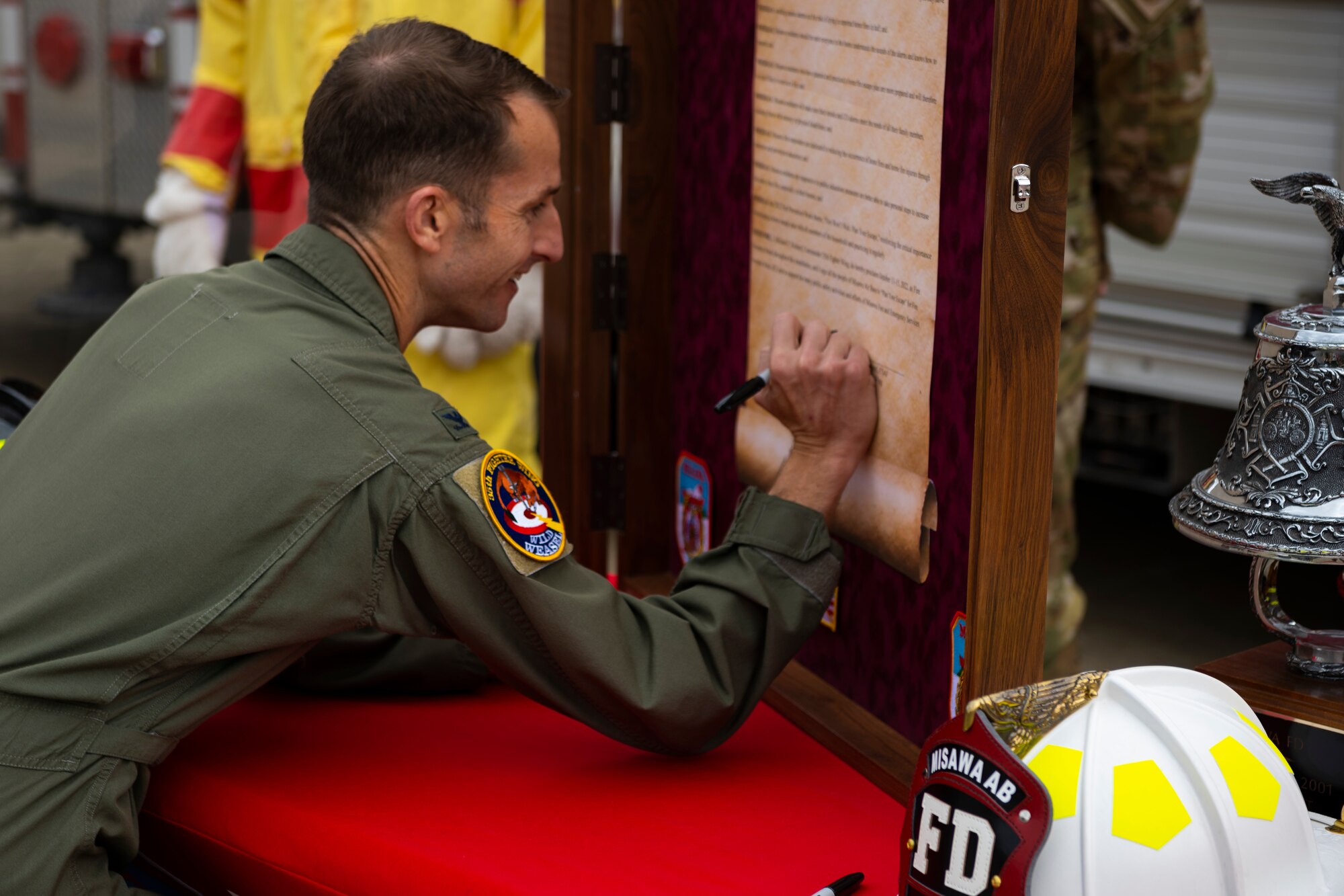 Air Force member signing a proclamation