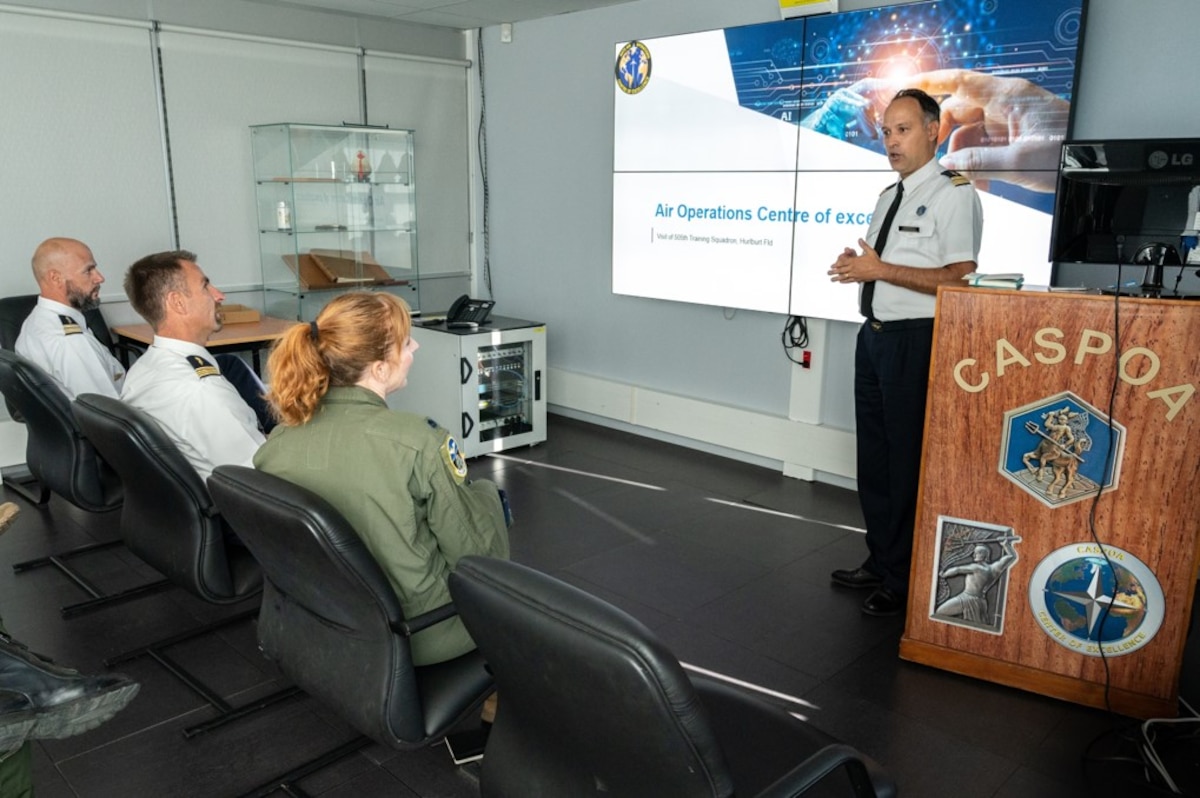photo of French air force member briefing a  US military member sitting in chairs