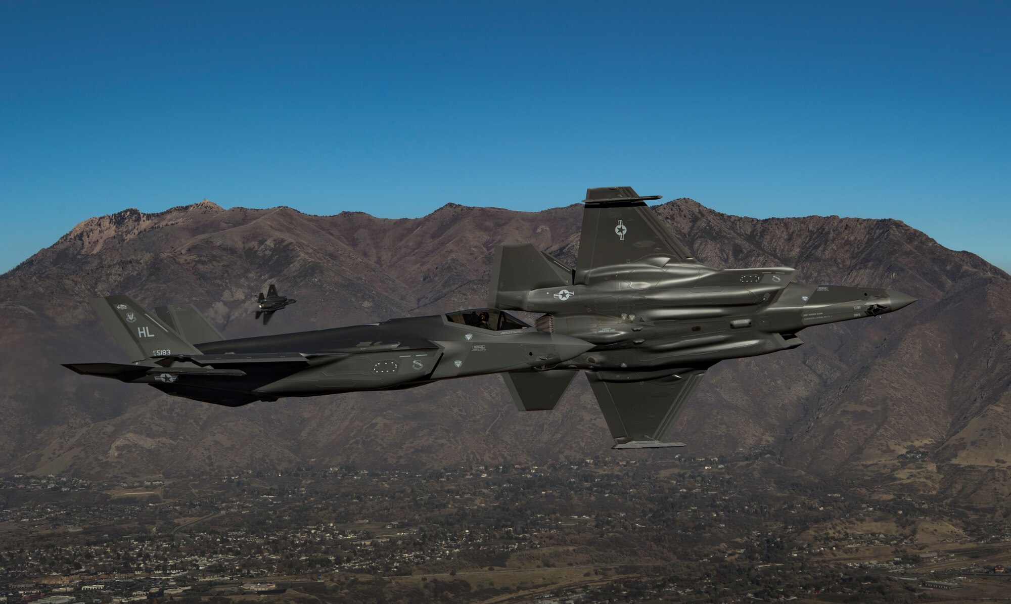 Two F-35A Lightning IIs, stationed at Hill Air Force Base, Utah, prepare to land over Hill AFB. (U.S. Air Force file photo by Staff Sgt. Andrew Lee)