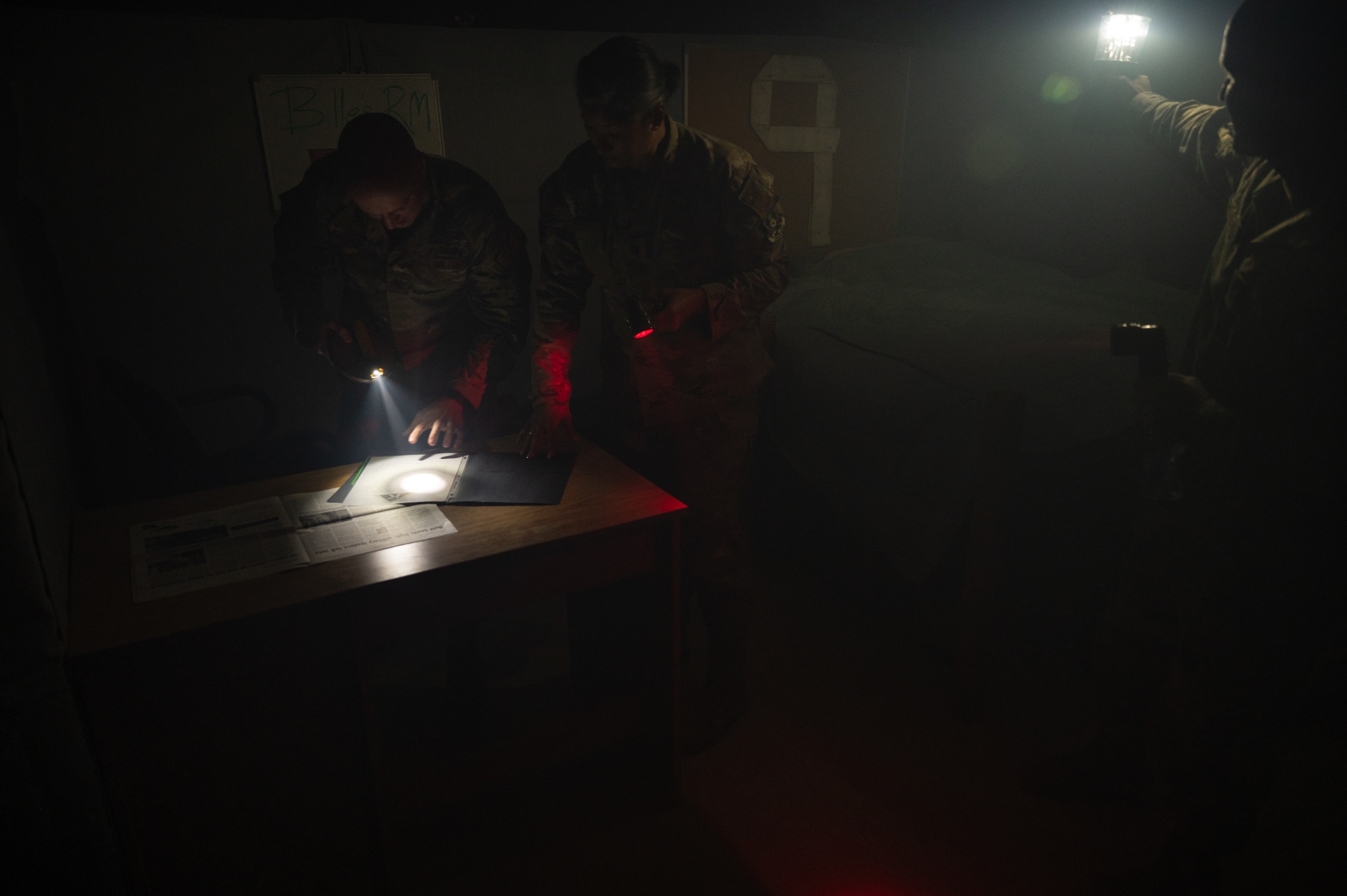 U.S. Air Force Airmen participate in a fire escape room exercise for fire safety awareness Oct. 12, 2022 at Al Udeid Air Base, Qatar. The Airmen worked together to find clues, unlock padlocks and perform a rescue as part of an exercise to impress upon people the importance and challenge of fire safety awareness.