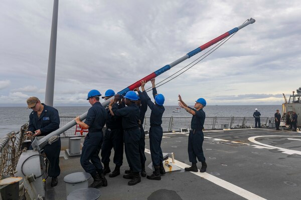 SATTAHIP, Thailand (Oct. 11, 2022) Sailors lower the flag staff on the flight deck aboard Arleigh Burke-class guided-missile destroyer USS Higgins (DDG 76) after a scheduled port visit in Sattahip, Thailand, Oct. 11. Higgins is assigned to Commander, Task Force 71/Destroyer Squadron (DESRON) 15, the Navy’s largest forward-deployed DESRON and the U.S. 7th Fleet’s principal surface force. (U.S. Navy photo by Mass Communication Specialist 1st Class Donavan K. Patubo)