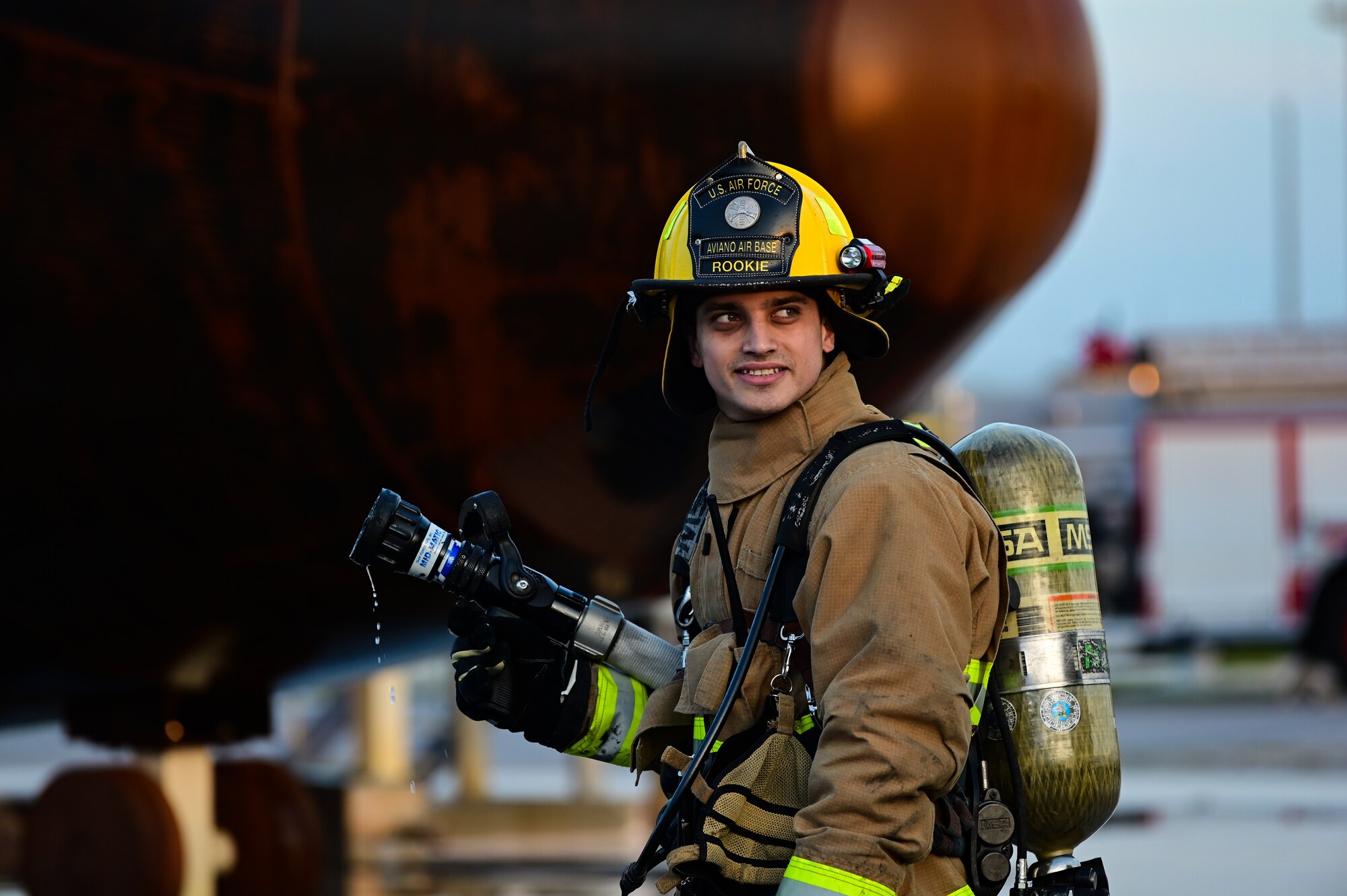 U.S. Air Force Senior Airman Giovanni Guercia, 31st Civil Engineer Squadron firefighter, waits for a live fire exercise to begin at Aviano Air Base, Italy, Oct. 12, 2022. Live fire training is conducted in a burn building or area, which is built to be intentionally burned for firefighter training. (U.S. Air Force photo by Senior Airman Thomas S. Keisler IV)