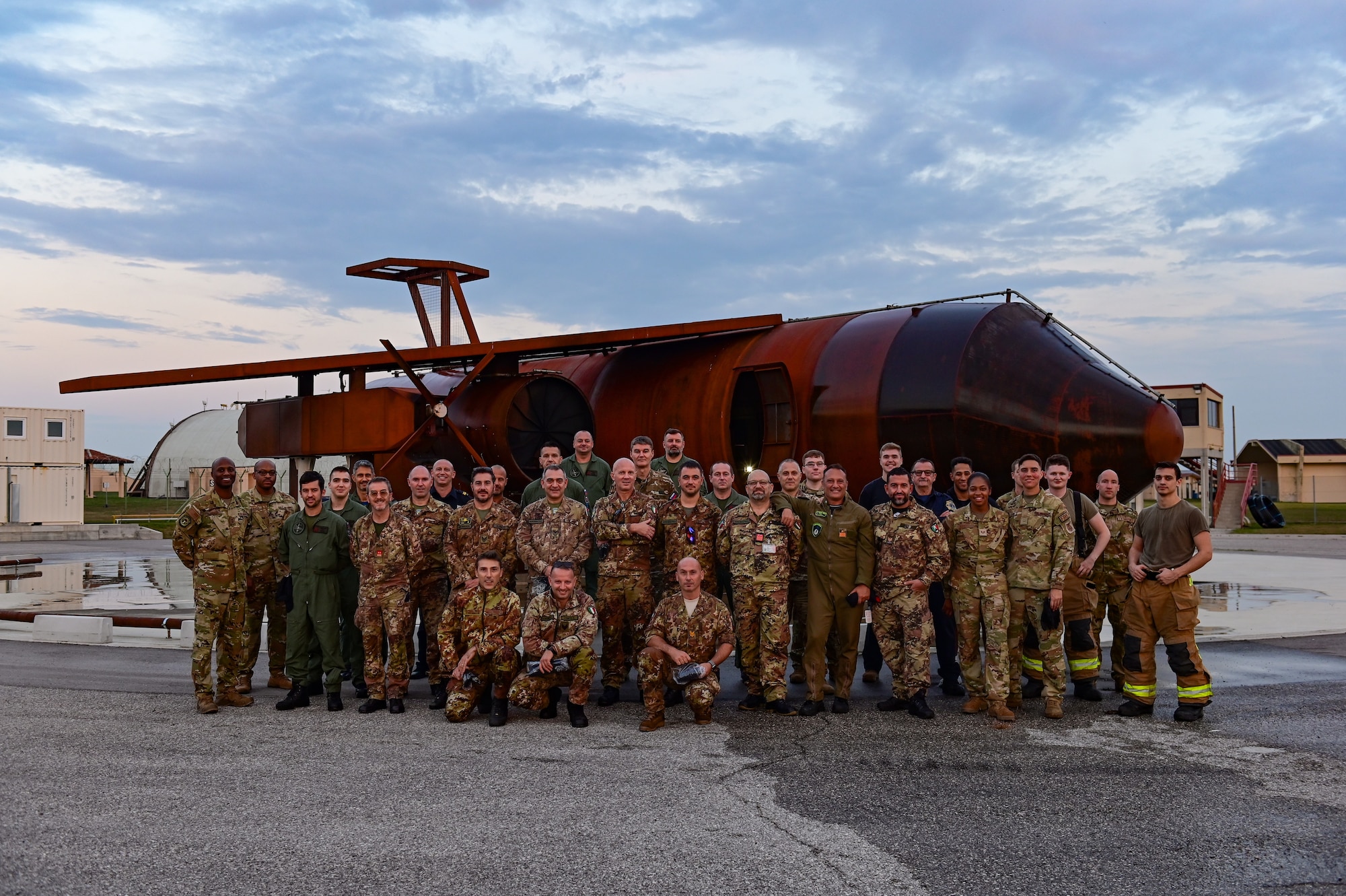 Members of the 31st Civil Engineer Squadron fire department pose with Slovenian air force and Italian firefighters after a live fire exercise at Aviano Air Base, Italy, Oct. 12, 2022. The Italian and Slovenian fire fighters toured Aviano AB to witness the base’s capabilities and to set up future multinational trainings to further develop interoperability. (U.S. Air Force photo by Senior Airman Thomas S. Keisler IV)