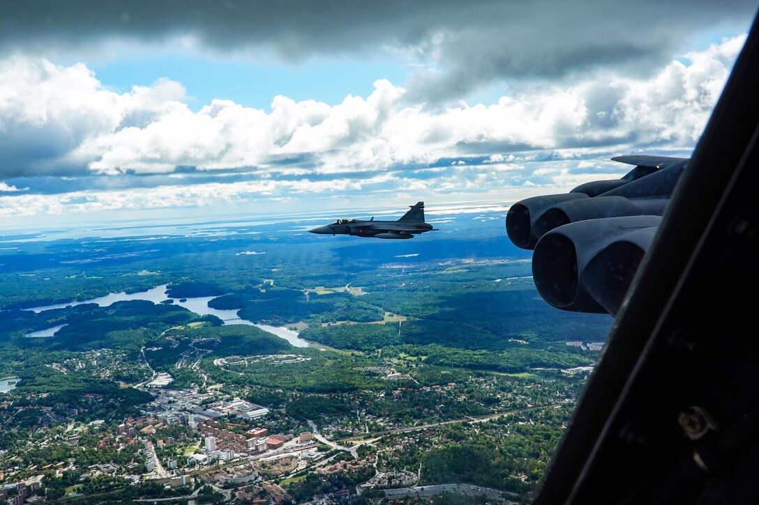 A foreign military jet escorts a domestic military jet.