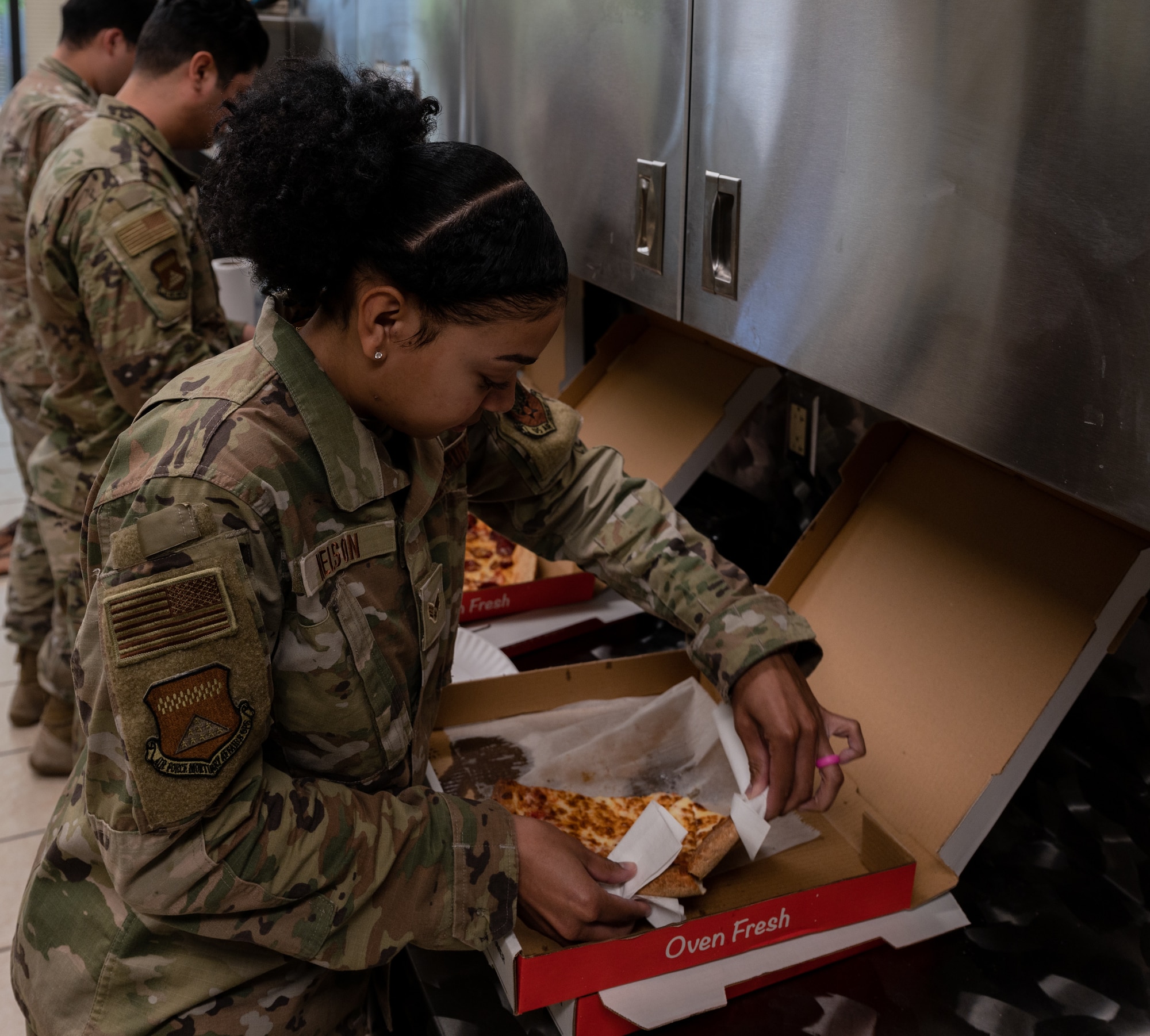 Airman grabs a slice of pizza