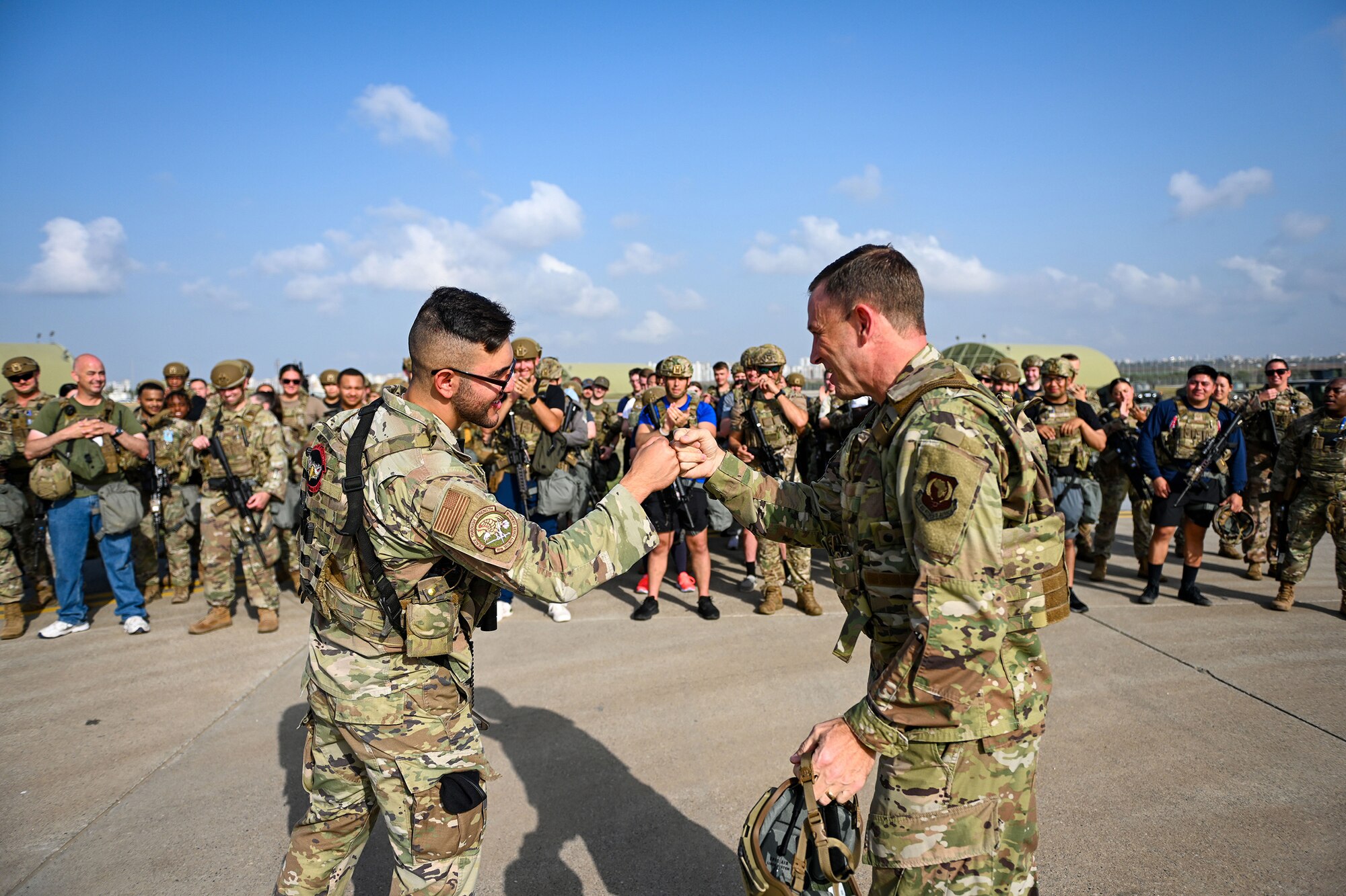 Lt. Gen. John Lamontagne, right, United States Air Forces in Europe and Air Forces Africa deputy commander, fist bumps Airman Nathaniel Titus, a security forces apprentice assigned to the 39th Security Forces Squadron, after coining him at Incirlik Air Base, Turkey, Oct. 3, 2022.