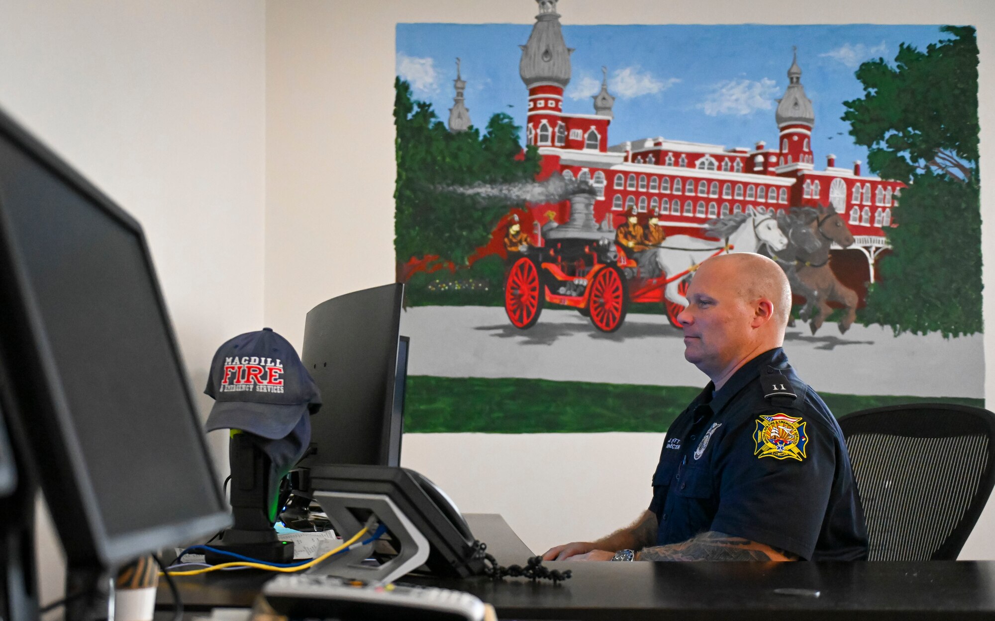 Jay Scott, a fire inspector assigned to the 6th Civil engineering Squadron works near a mural he painted at MacDill Air Force Base, Florida, Oct. 13, 2022. The mural depicts firefighters operating a horse drawn carriage near the formal Tampa Bay Hotel. A 20-year Air Force veteran with over 30 years of experience in fire prevention, Scott saw an opportunity to pay tribute to those who came before him and share those stories with new Airmen through art. (U.S. Air Force photo by Airman 1st Class Lauren Cobin)