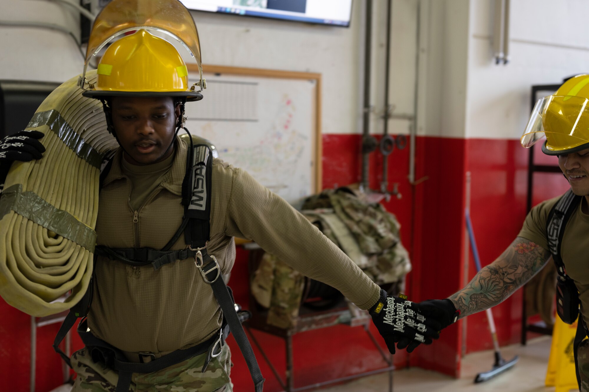 An airman gets tagged in by a teammate during the Fire Muster.