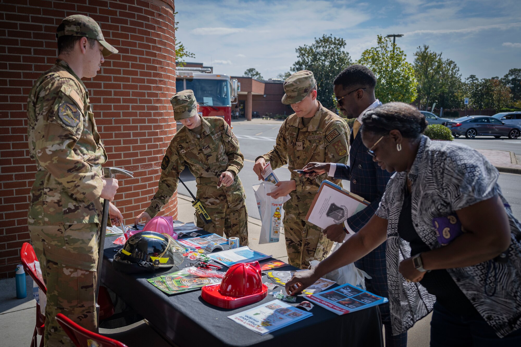 Airmen assigned to the 4th Civil Engineer Squadron hand out informative materials during Fire Prevention Week at Seymour Johnson Air Force Base, North Carolina, Oct. 12, 2022. FPW takes place annually on the Sunday-Saturday period that includes Oct. 9th, the anniversary of the Great Chicago Fire