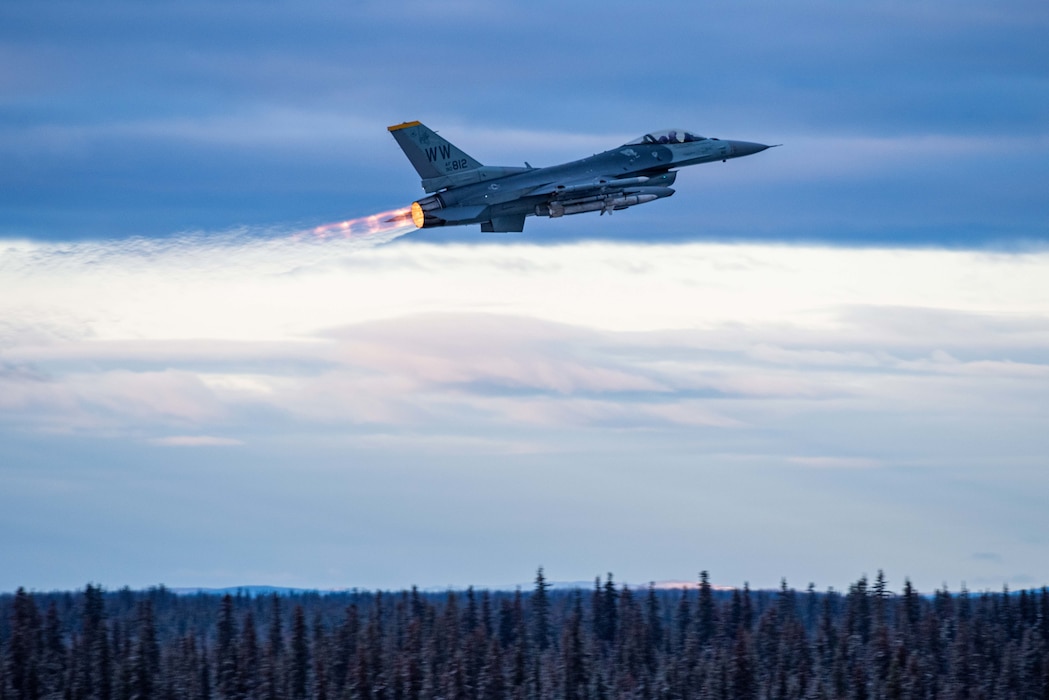A lone U.S. Air Force F-16 Fighting Falcon from the 14th Fighter Squadron takes off at Eielson Air Force Base, Alaska, at the start of RED FLAG-Alaska 23-1 Oct. 10, 2022.