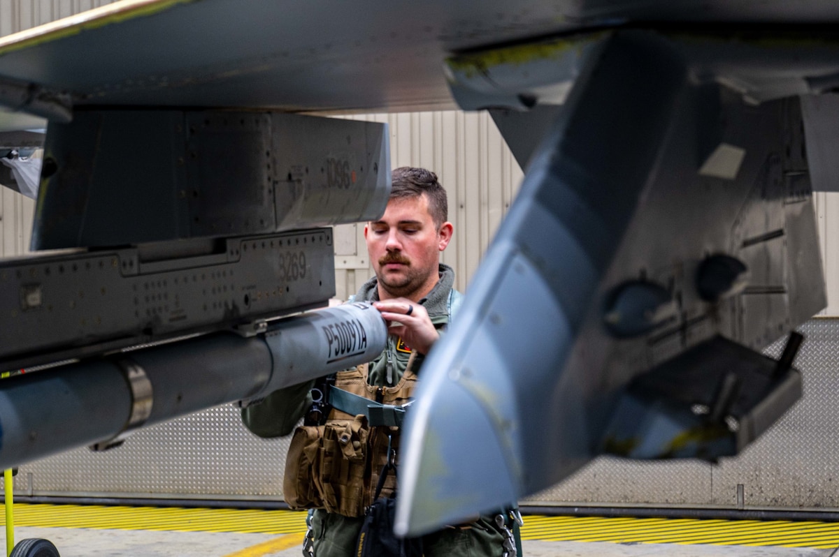 U.S. Air Force Captain Aaron Doyle, 14th Fighter Squadron wing flight safety officer, performs a pre-flight inspection on his F-16 Fighting Falcon at Eielson Air Force Base, Alaska, during RED FLAG-Alaska 23-1, Oct. 13, 2022.
