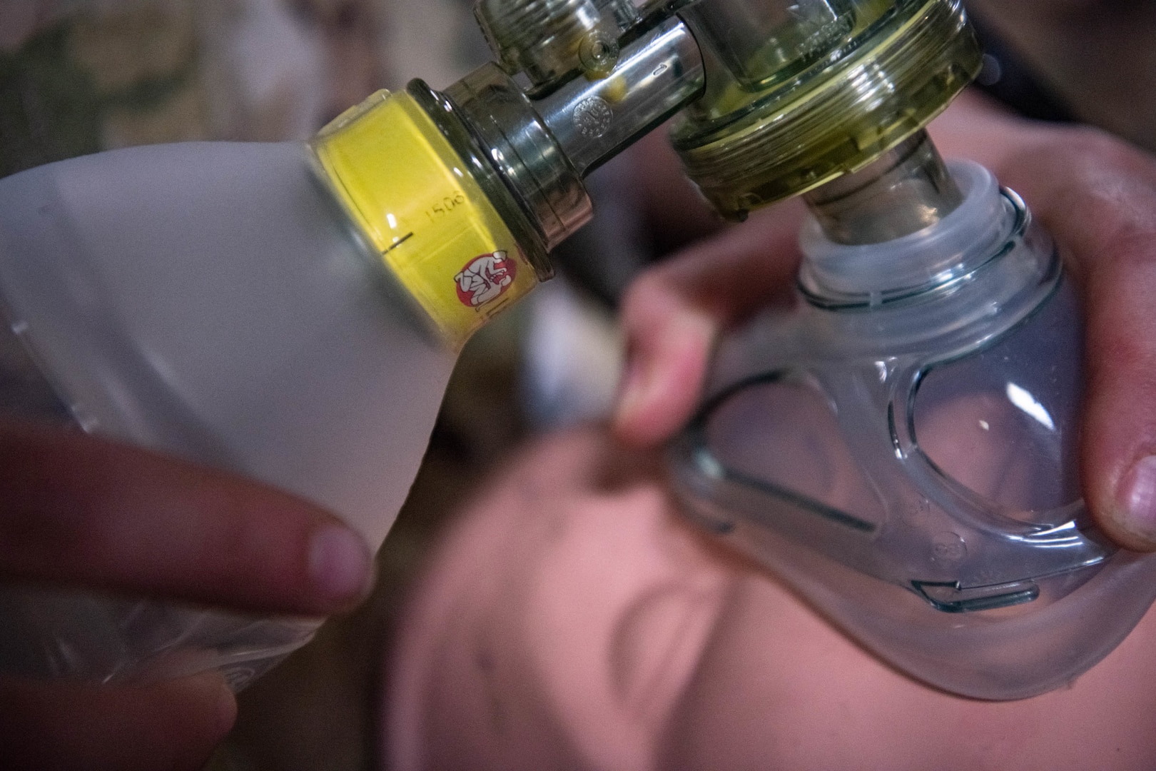 a bag valve mask is placed over a mannequin that is simulating a patient