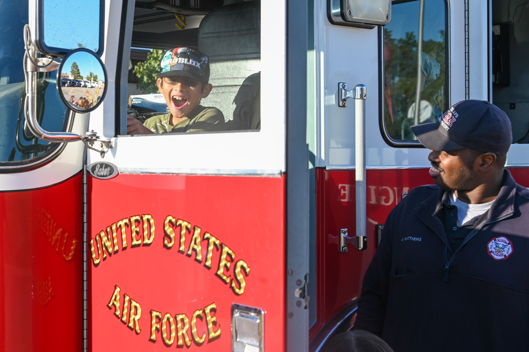 An L. Mendel Rivers Elementary student sits in a fire truck at Altus Air Force Base (AAFB), Oklahoma, Oct. 12, 2022. Students had the opportunity to tour the fire truck, tried on firefighting gear and learned more about what firefighters do at AAFB. (U.S. Air Force photo by Senior Airman Kayla Christenson)