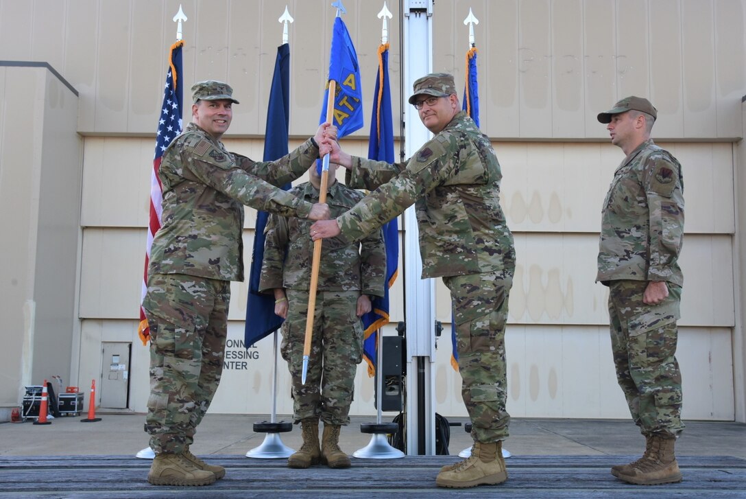 Chief Master Sgt. Scott Woods, 111th Attack Wing command chief master sergeant, accepts authority as command chief master sergeant from 111th ATKW Commander Col. Deane Thomey, far left, during a ceremony at Biddle Air National Guard Base in Horsham, Pennsylvania, Oct. 15, 2022. Woods previously served as the Senior Enlisted Leader of the 111th Operations Support Squadron at Biddle ANG Base.