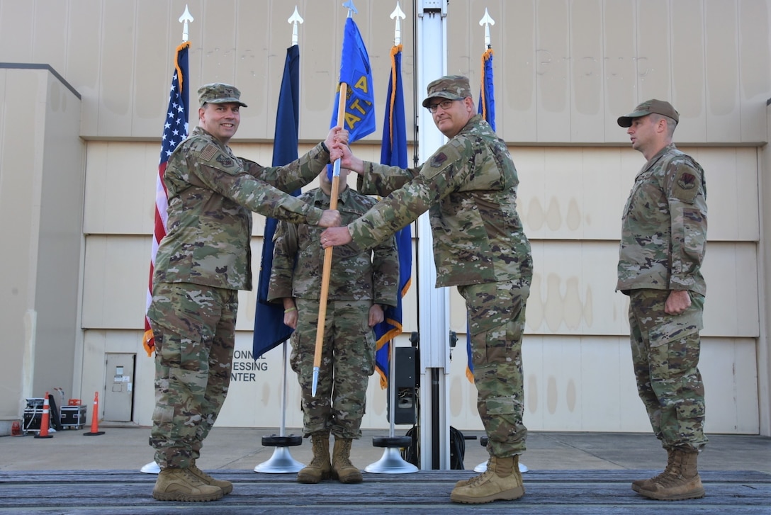 Chief Master Sgt. Scott Woods, 111th Attack Wing command chief master sergeant, accepts authority as command chief master sergeant from 111th ATKW Commander Col. Deane Thomey, far left, during a ceremony at Biddle Air National Guard Base in Horsham, Pennsylvania, Oct. 15, 2022. Woods previously served as the Senior Enlisted Leader of the 111th Operations Support Squadron at Biddle ANG Base.