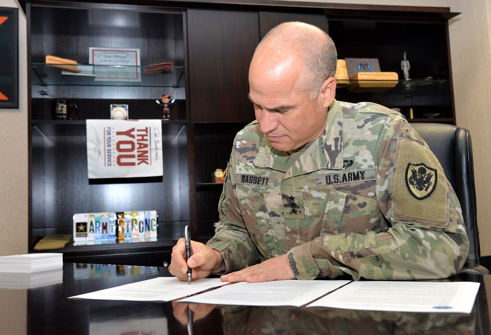 Photo of Army Lt. Gen. David Bassett, Defense Contract Management Agency director, signing the updated CARES Council charter Oct. 6, 2022.