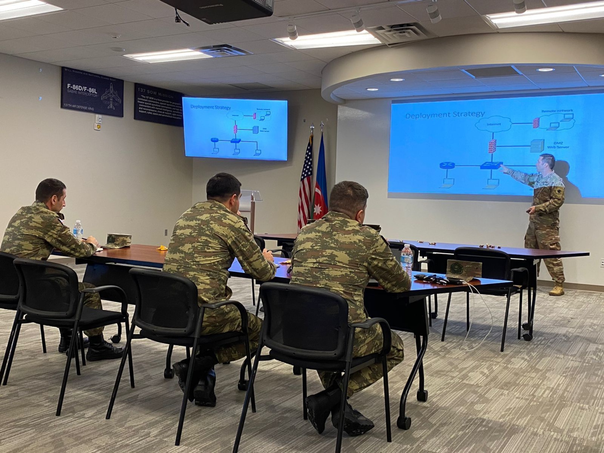 Cybersecurity officers from the Azerbaijan army listen to a presentation by an Oklahoma Air National Guard member during a cybersecurity knowledge exchange hosted by the Oklahoma National Guard at the Will Rogers Air National Guard Base in Oklahoma City. The Oklahoma National Guard hosted a multiday exchange focused on building cooperation between the two partners.
