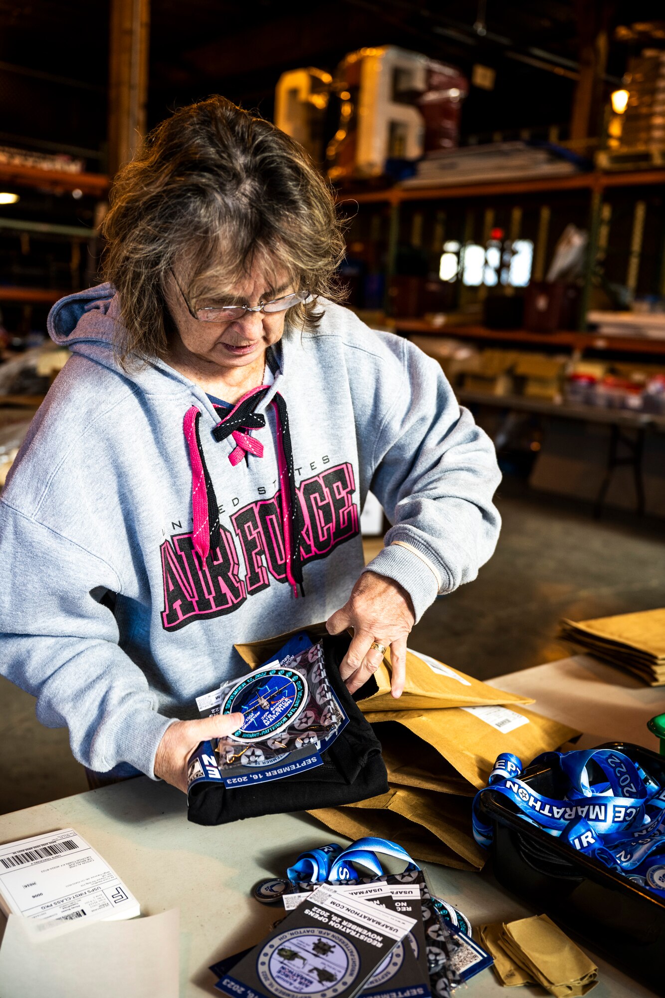 Air Force Marathon volunteer packs a virtual marathoner’s participation merchandise.