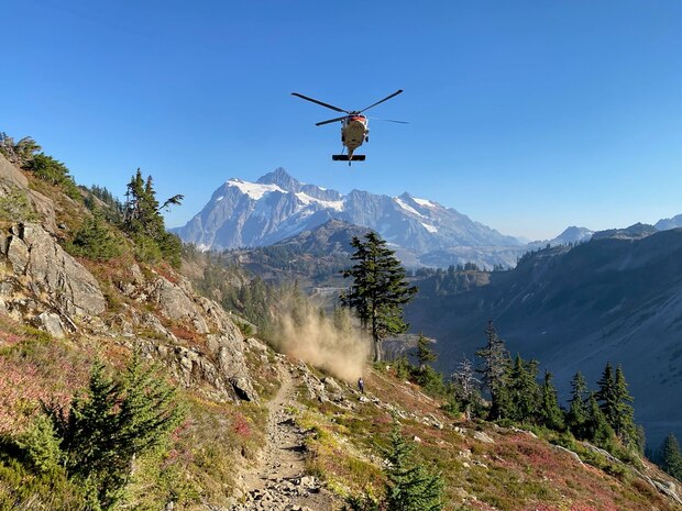 The Naval Air Station Whidbey Island Search and Rescue helicopter approaches to insert two crewmembers during a rescue of a hiker suffering from a heat related issue October 15, 2022.