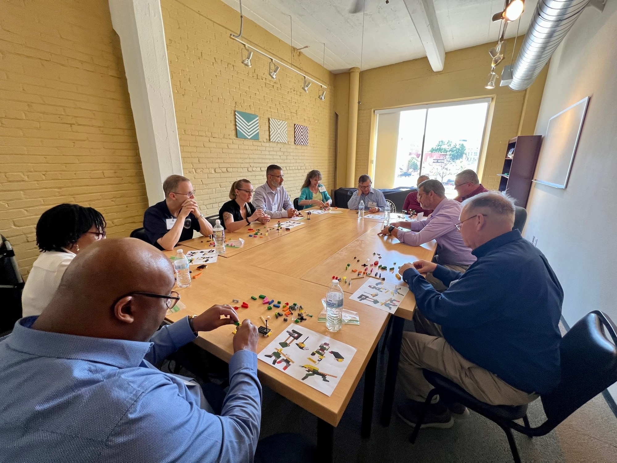 people around table building blocks