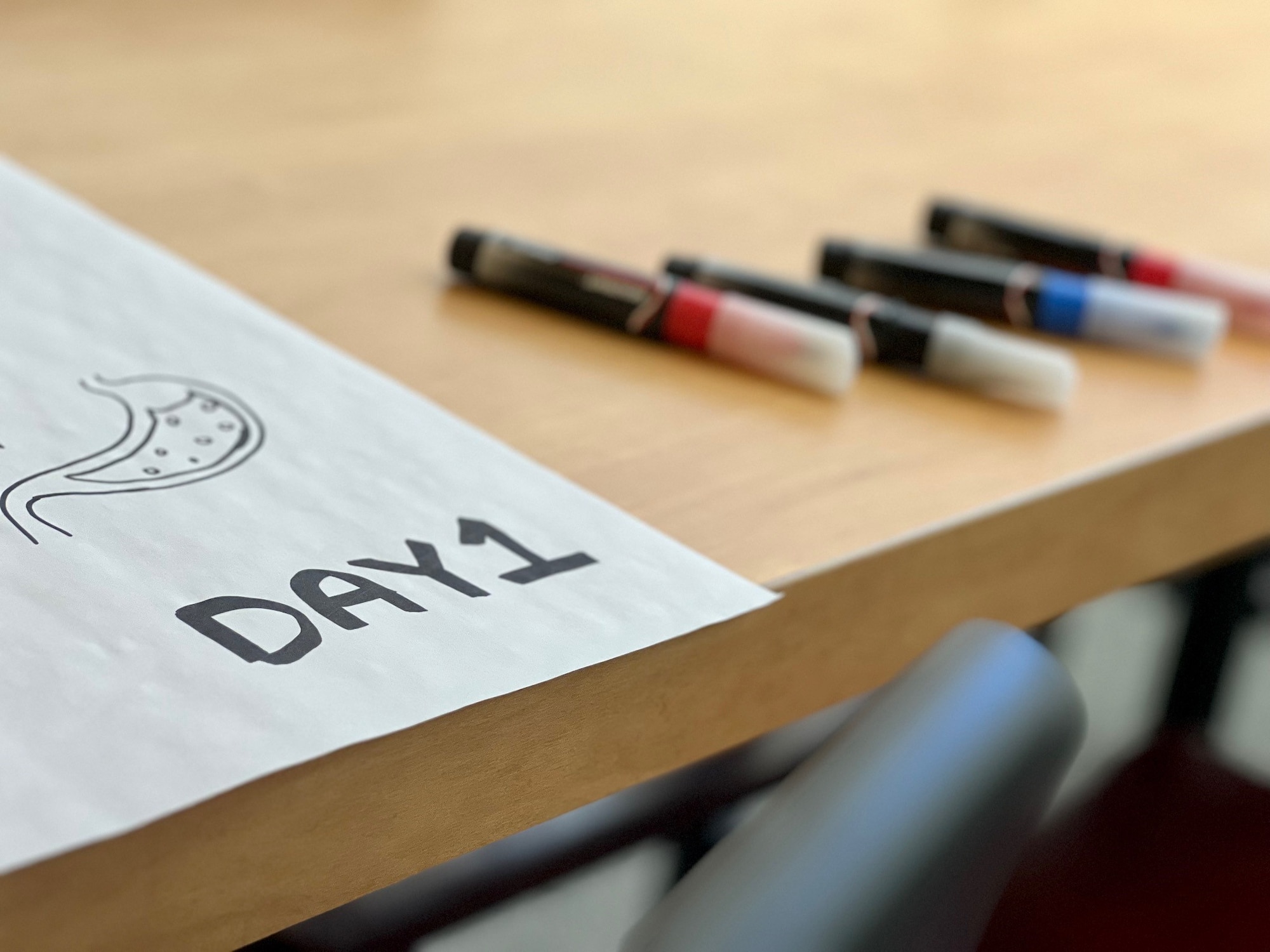 markers and paper on a table