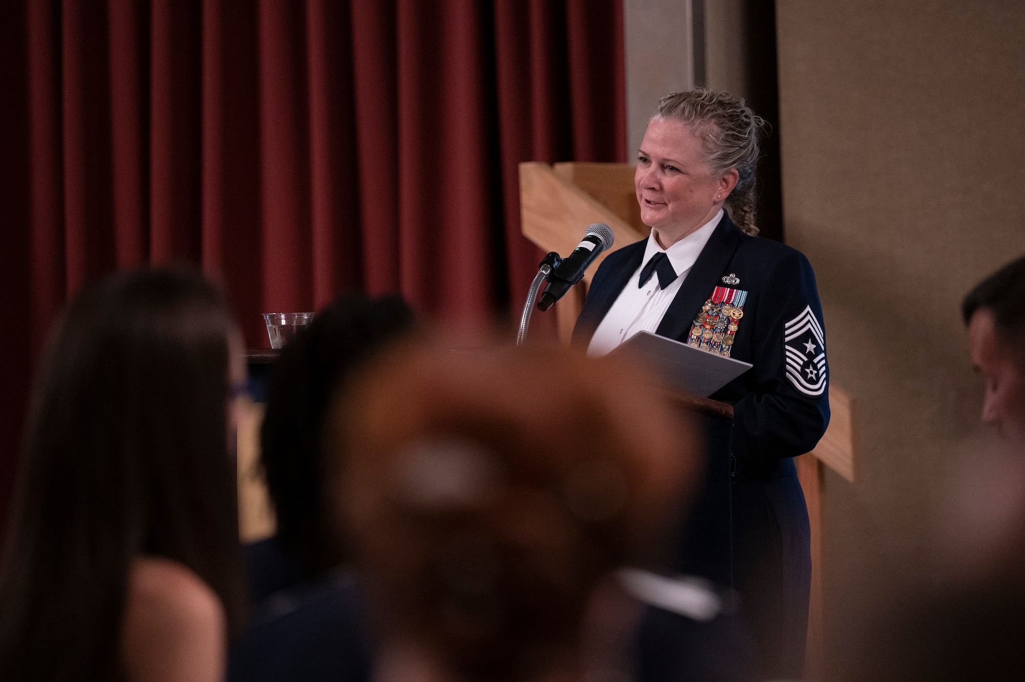 A woman speaks at a podium.