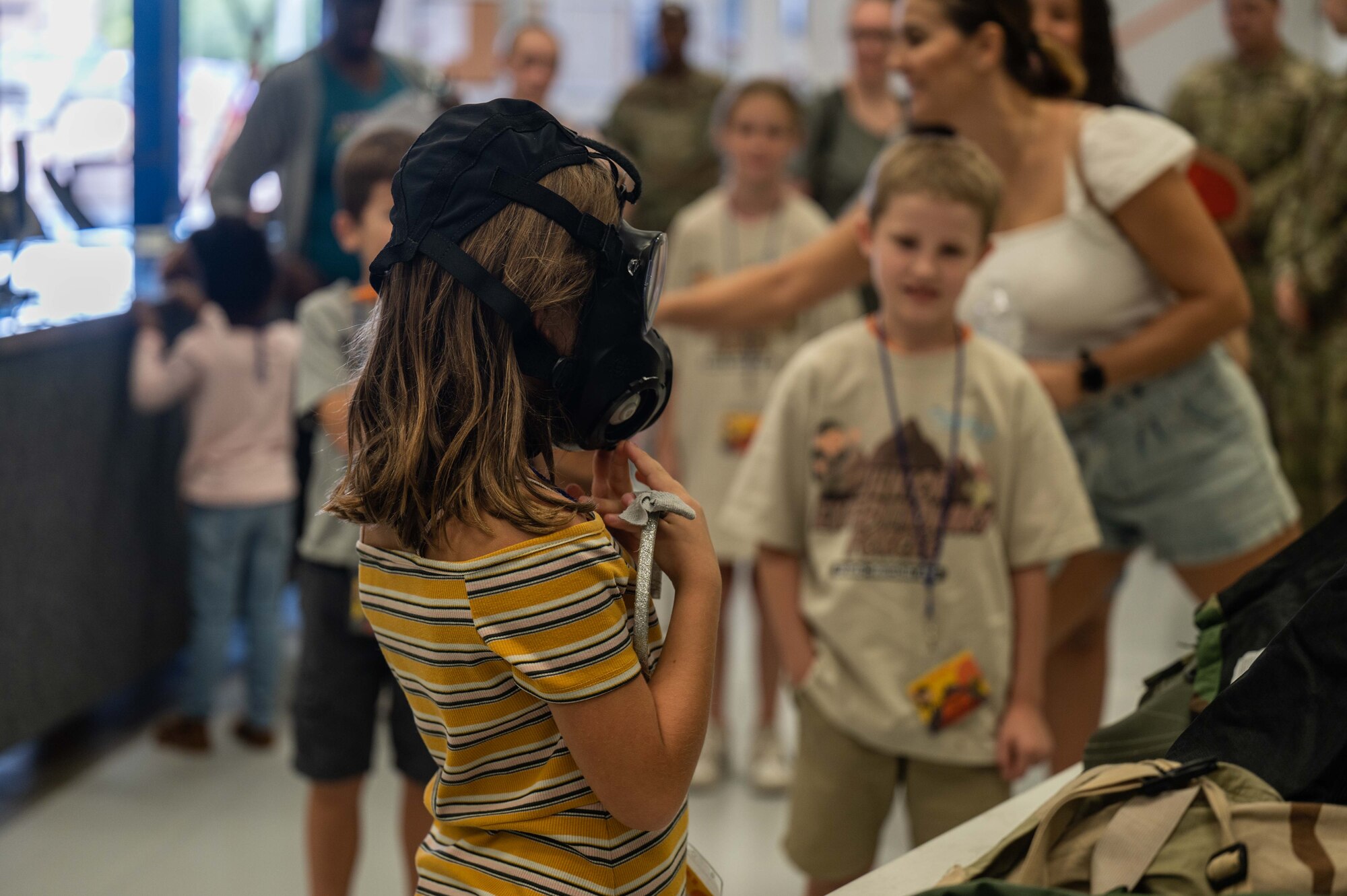 A photo of kids trying on military equipment