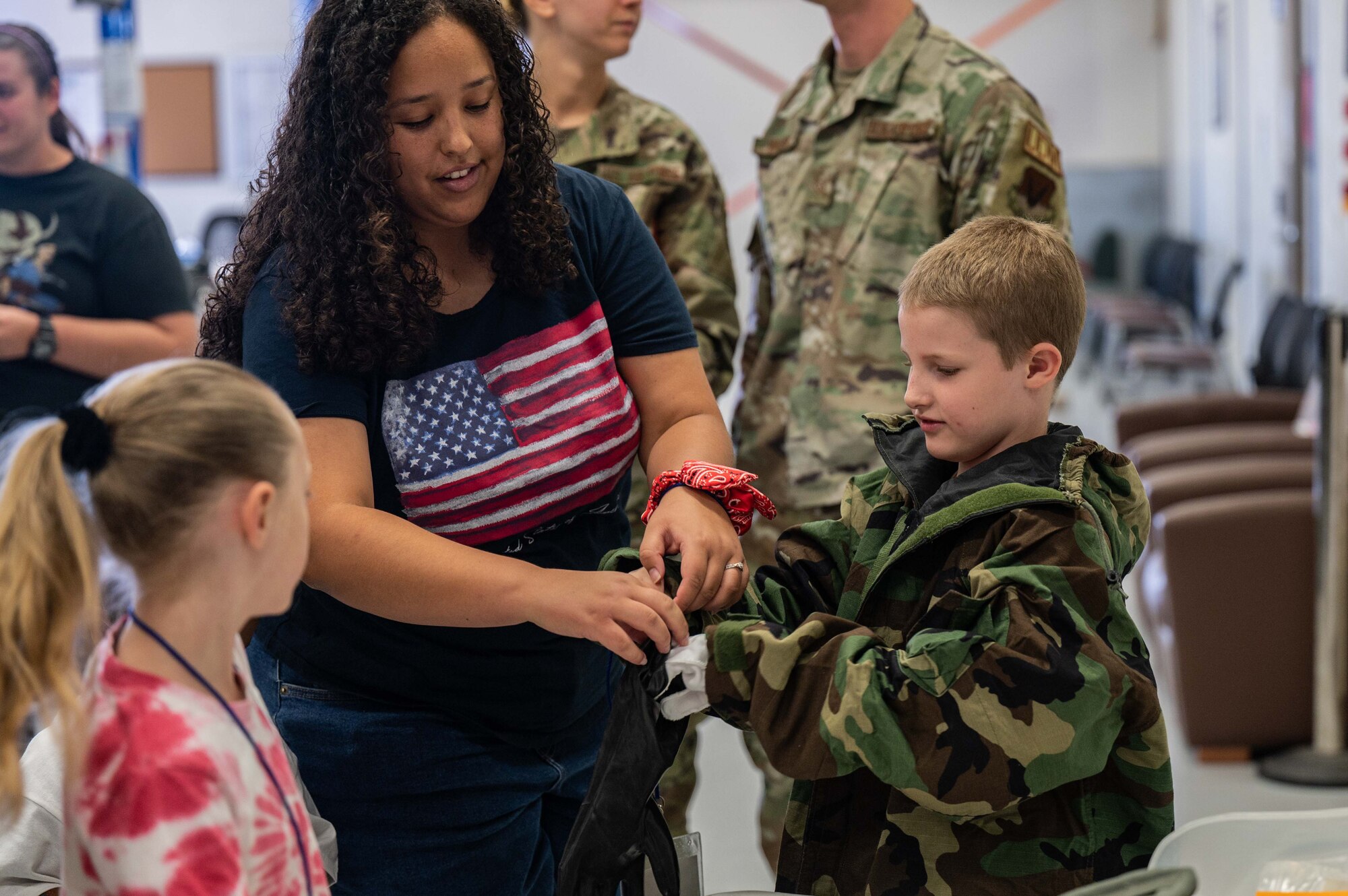 A photo of kids trying on military equipment